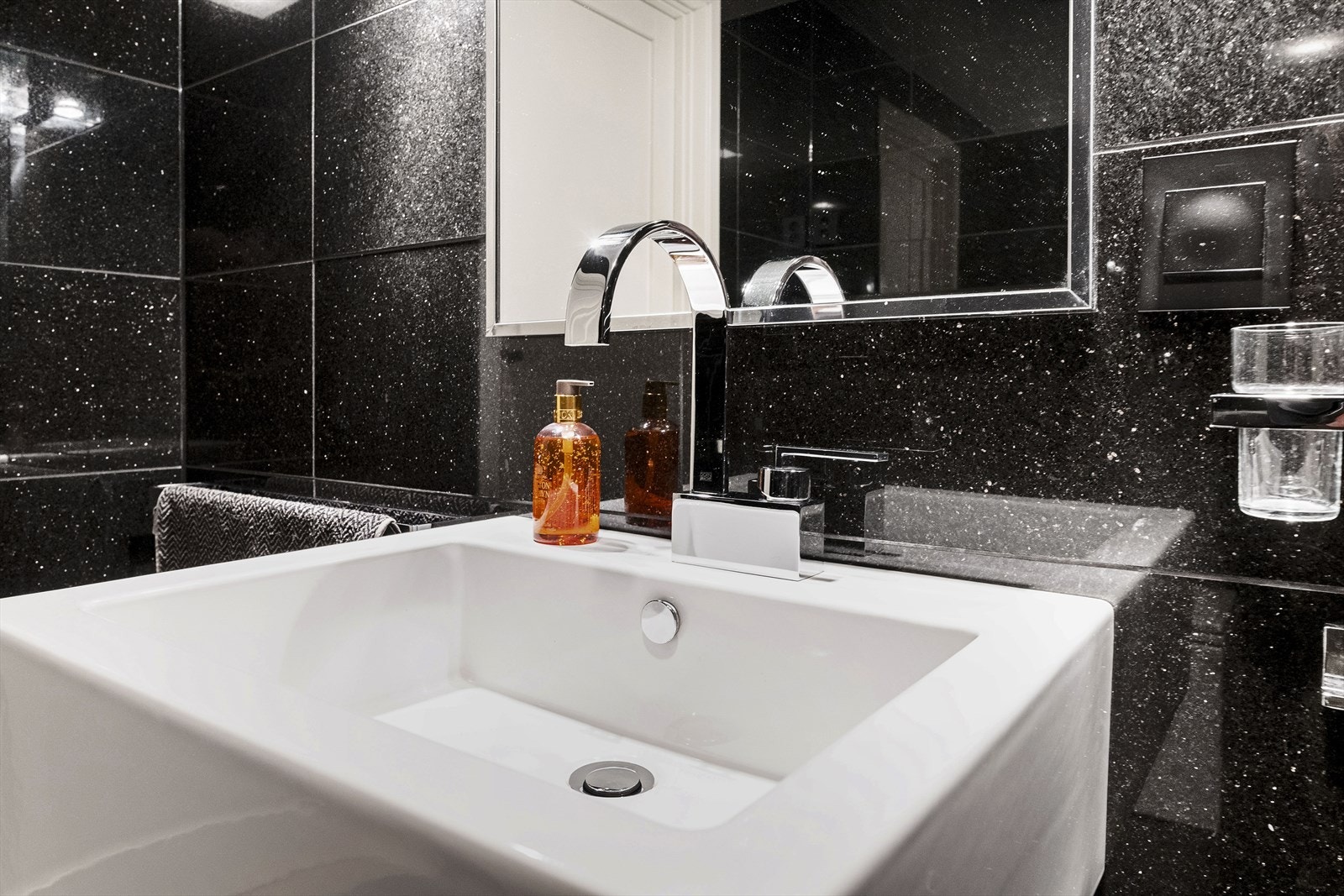 Detaljer fra hovedbadet med vegghengt servant. Galleribilde