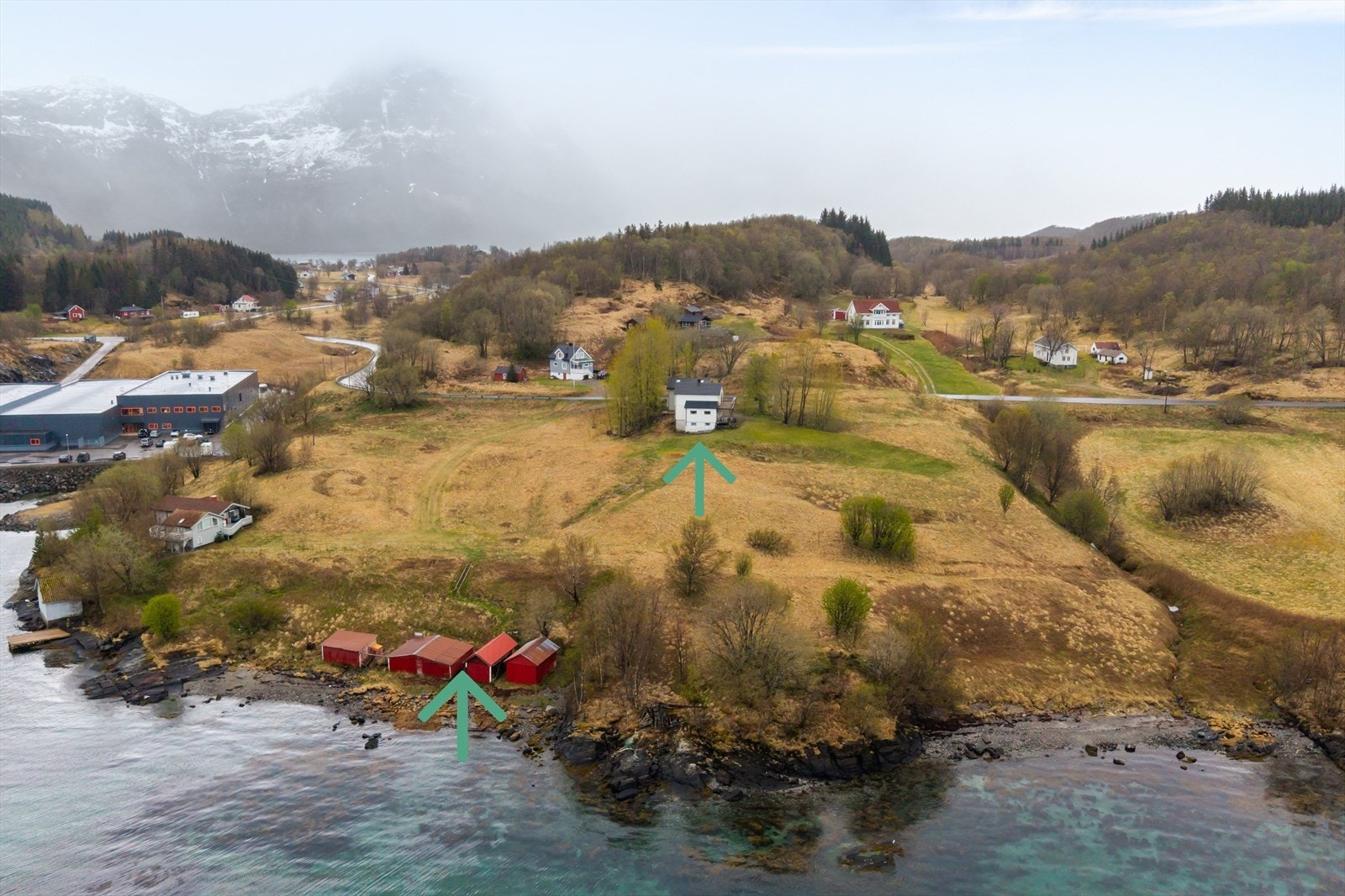 Dronefoto med bilde av 4 naust og opp mot boligen Galleribilde