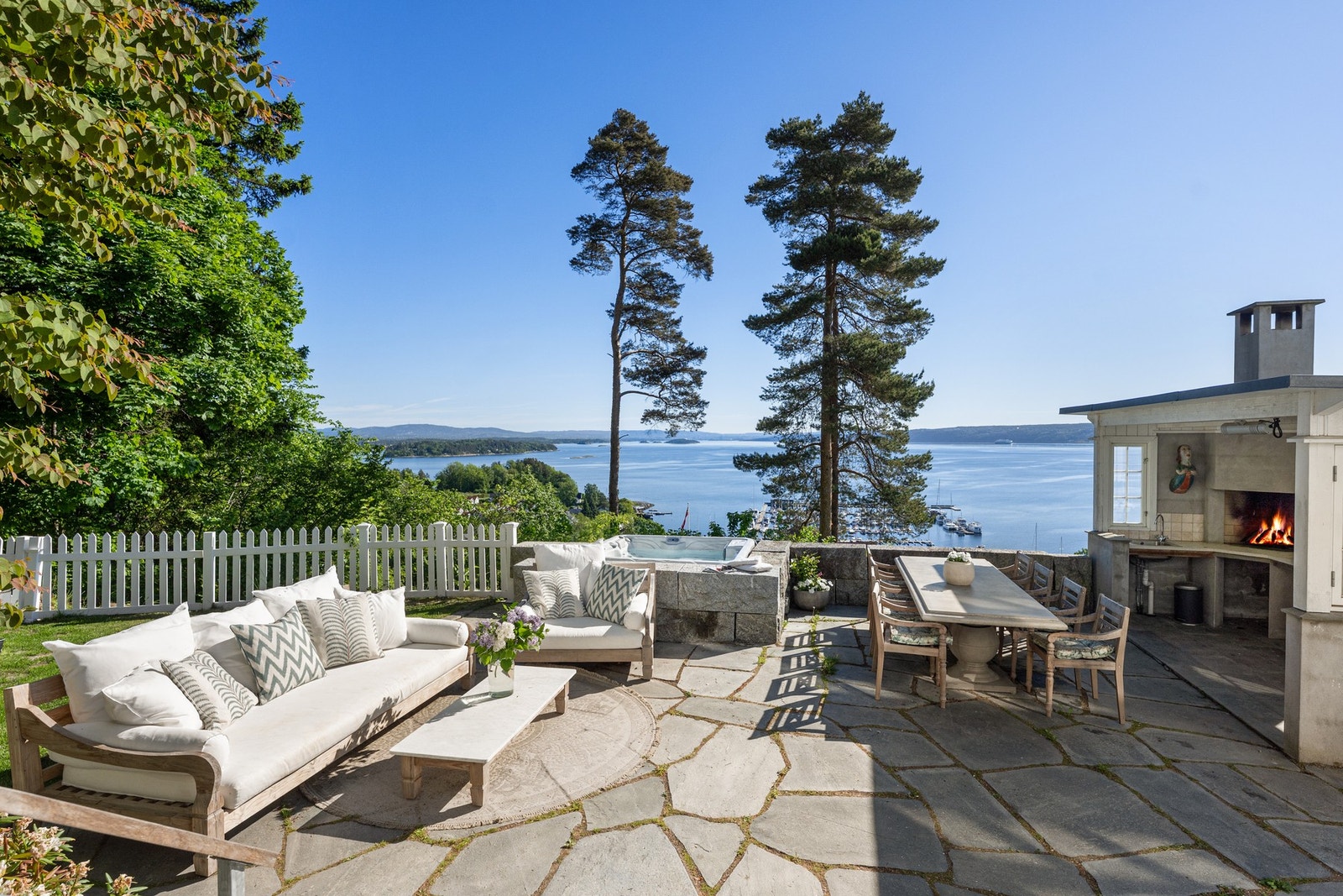 Fantastiske uteområder med natursteinsbelagte terrasser, peis og jacuzzi. Her ligger alt til rette for hyggelige sammenkomster med familie og venner gjennom store deler av året. Galleribilde