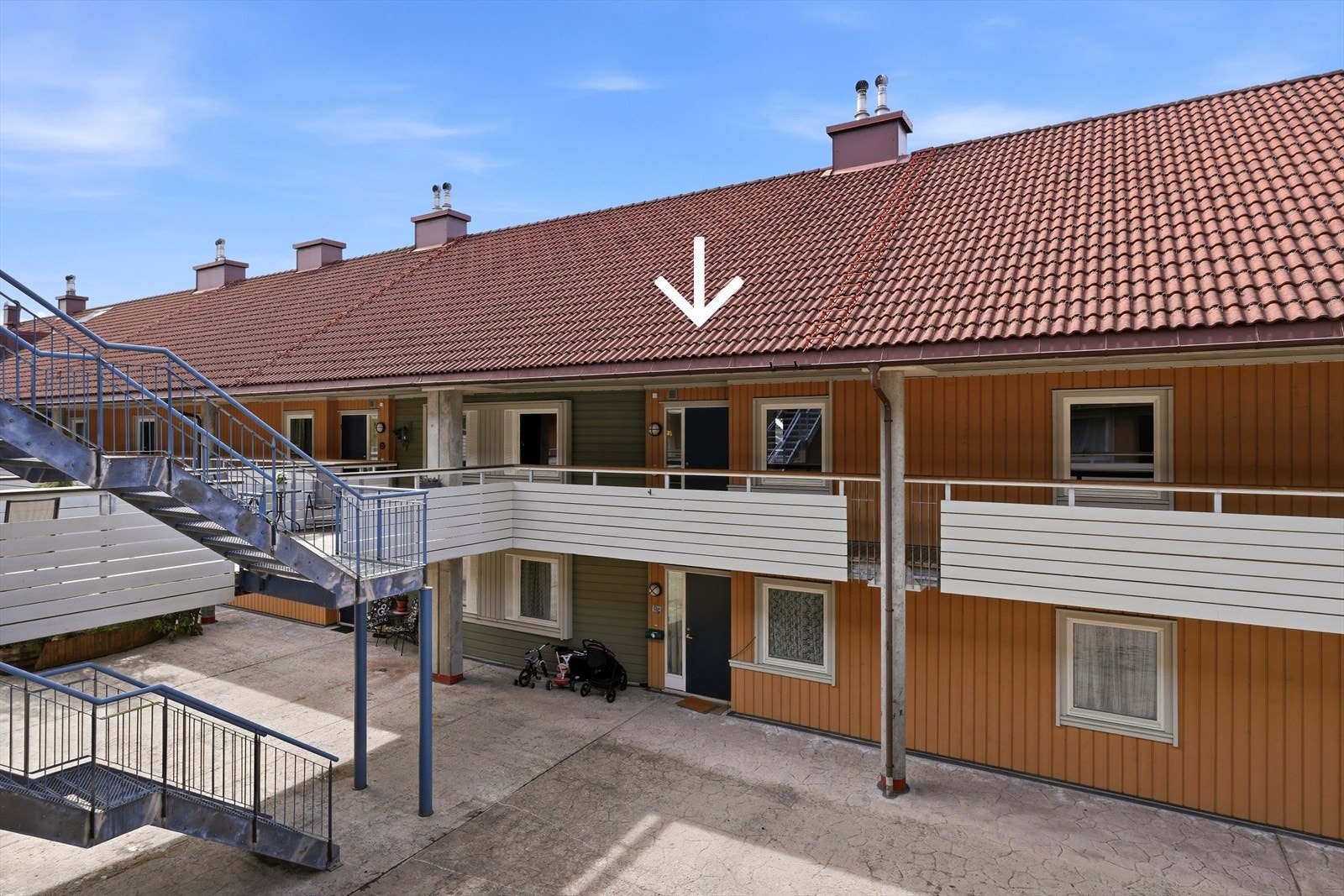 Inngangsdøra finner man omtrent på midten av det åpne atriumet, mot vest. Her har man egen inngangsdør, og en takoverbygd svalgang over døra. Galleribilde