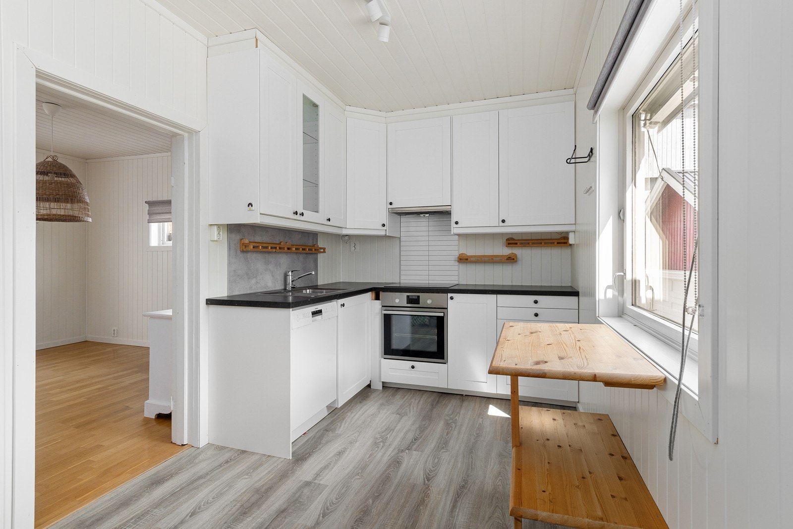Kjøkken med innredning med profilerte fronter og laminatbenkeplate. Rommet har laminatgulv. Galleribilde