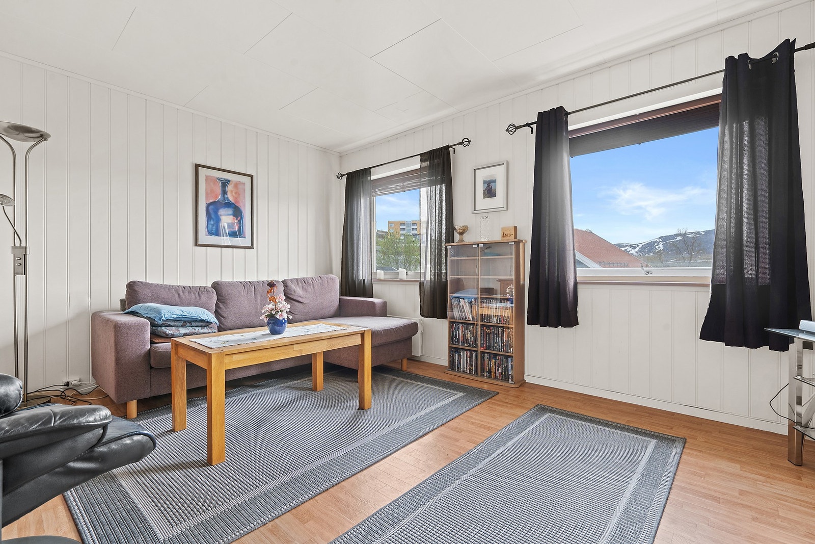 Stuen i andre etasje har vegger med trepanel og plass til en sofagruppe. Galleribilde