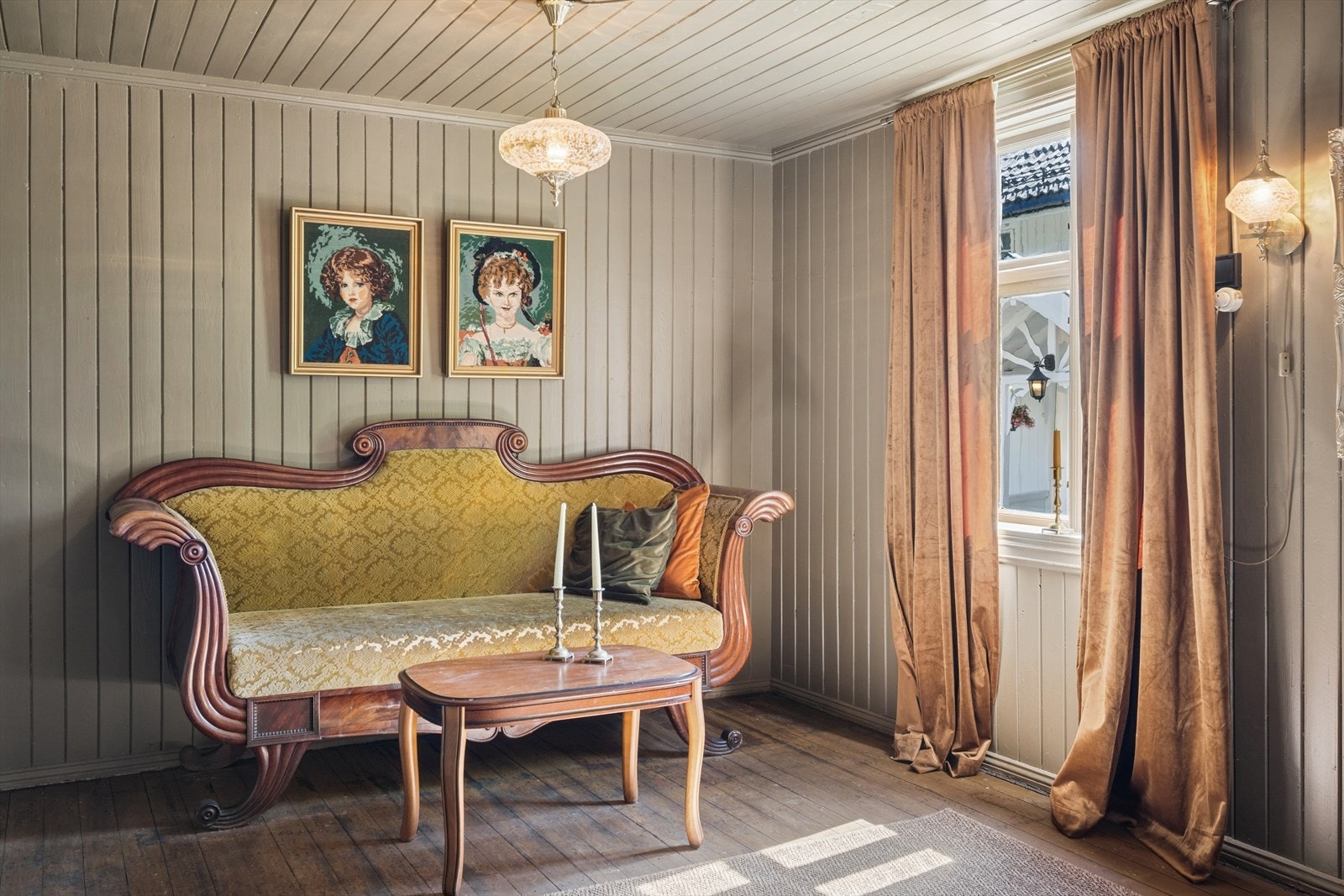 Stuen har panel på vegger og tak, som gir en lun og tradisjonell atmosfære. Galleribilde