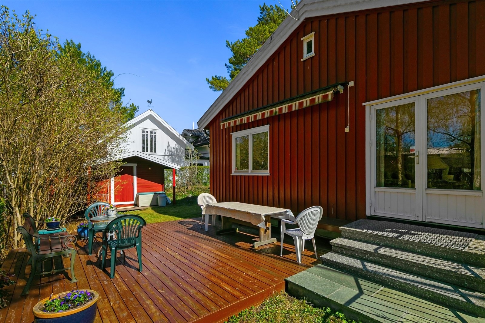 Fine hagearealer som omkranser boligen. Terrasse er utstyrt med markise. Galleribilde