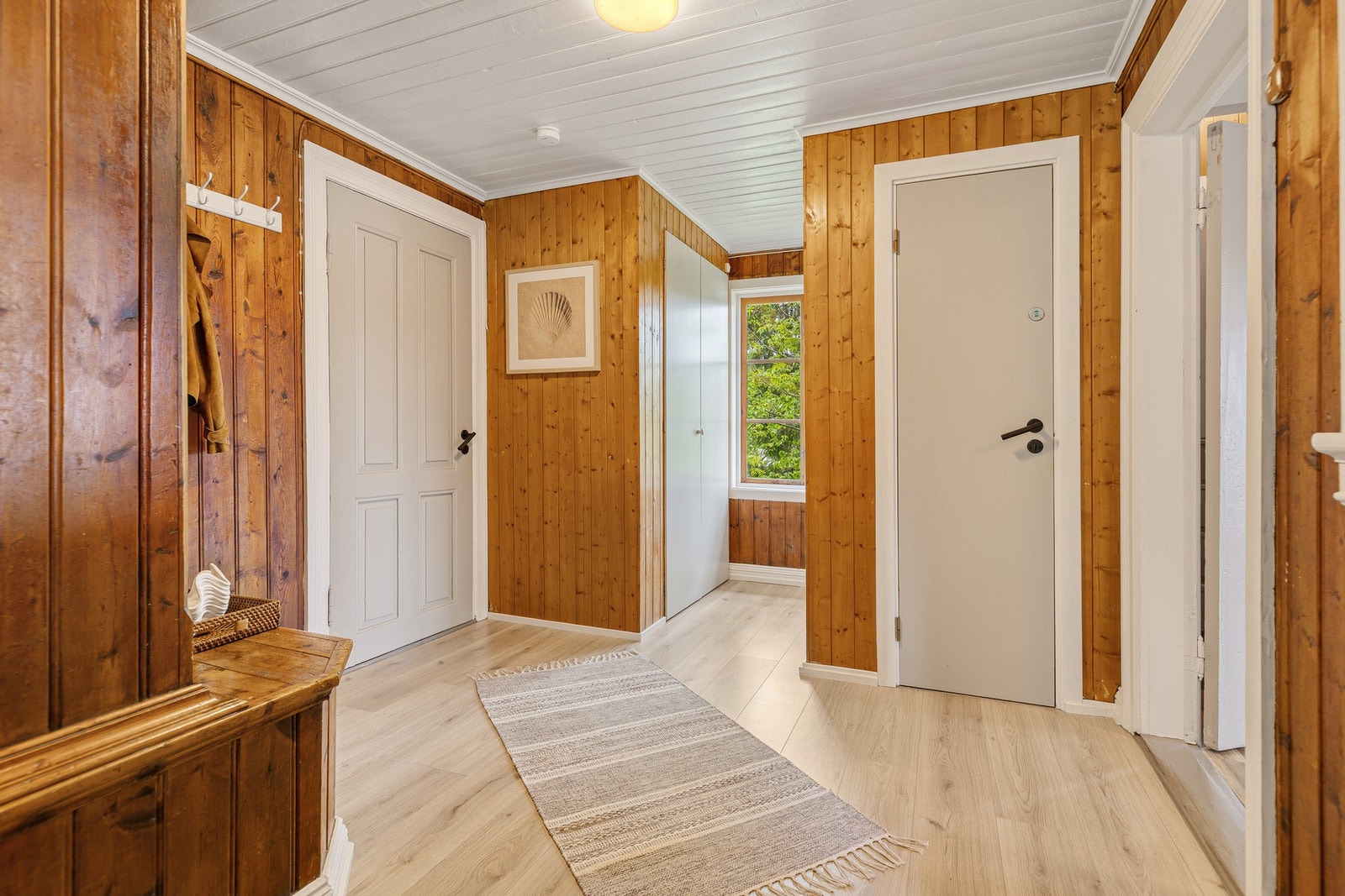 Velkommen inn i en romslig entrè/gang med god plass til oppbevaring av yttertøy og sko i garderobe. Galleribilde