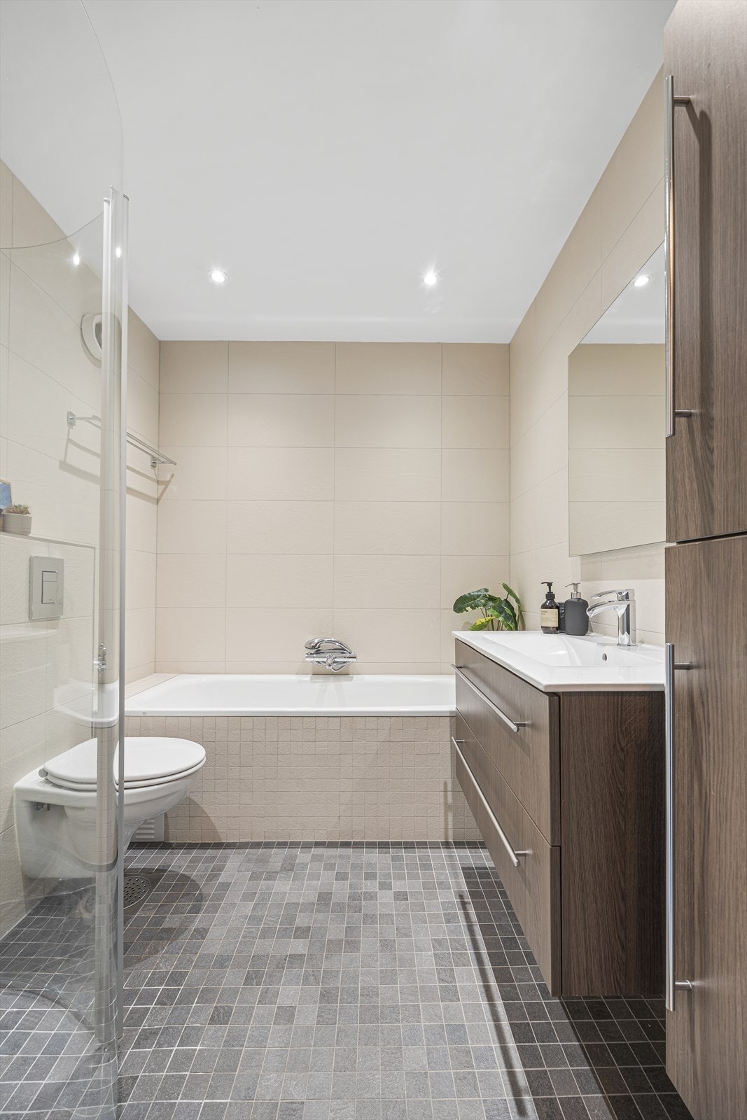 Badet har en tidløs og stilren innredning, og er utstyrt med både badekar og egen dusjsone. Galleribilde