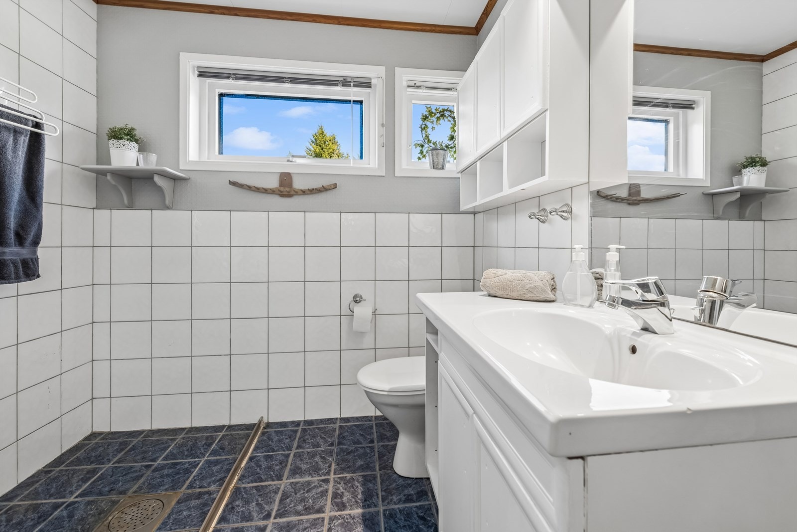 Badet i første etasje har flislagt gulv med varmekabler, dusjhjørne og baderomsinnredning. Galleribilde