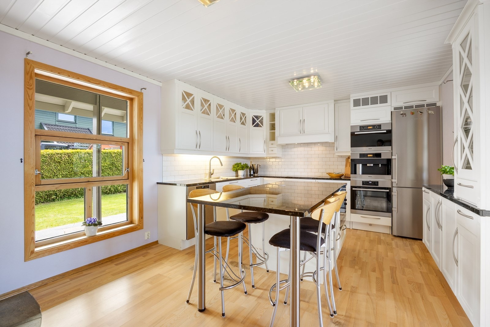 Kjøkkeninnredning fra Huseby fra 2009, med profilerte fronter og benkeplater i stein. Integrerte hvitevarer som kaffemaskin, platetopp, stekeovn, microbølgeovn og dampovn. Galleribilde