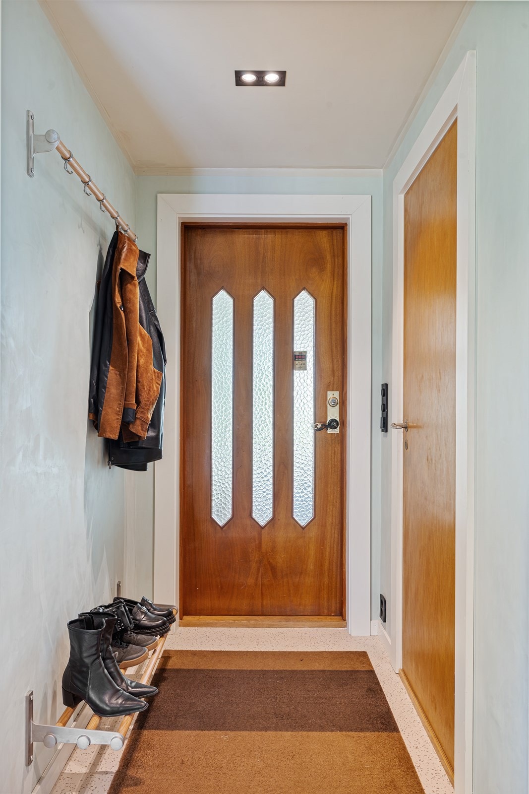 Fra overbygget inngangsparti kommer man inn til en romslig entrè/hall med plass til garderobeskap - originale dører er godt ivaretatt Galleribilde