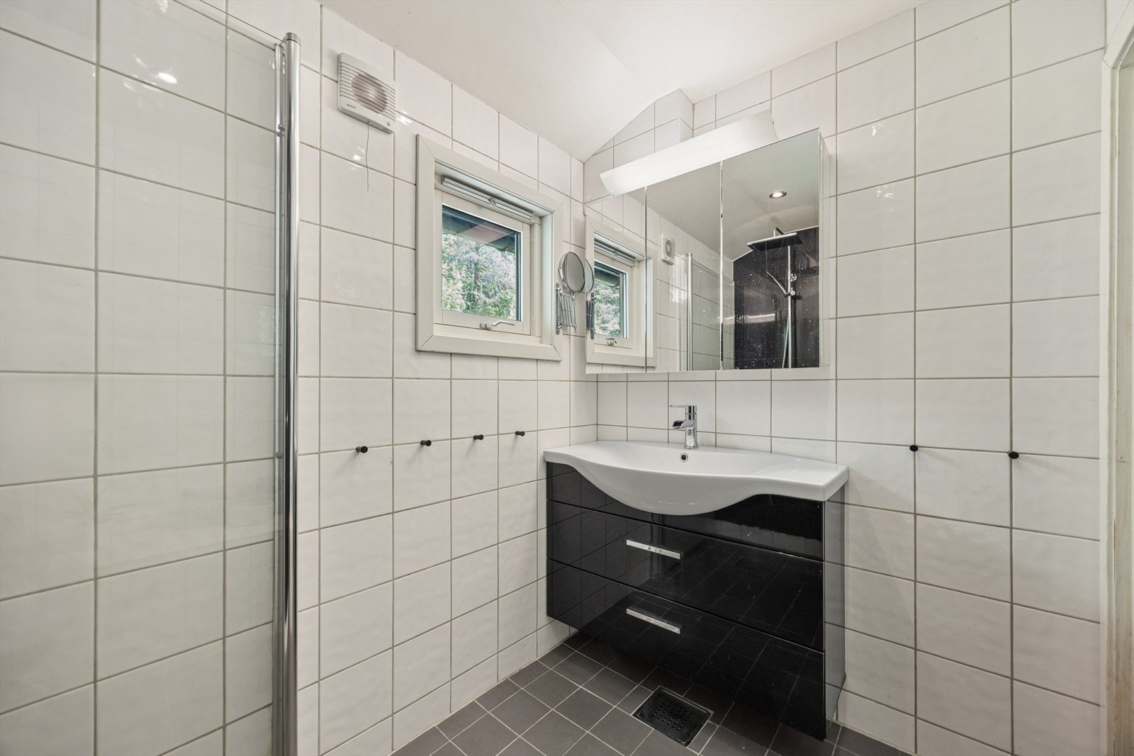 Badet har varmekabler i gulvet og er innredet med servantinnredning, speil og dusjløsning. Galleribilde