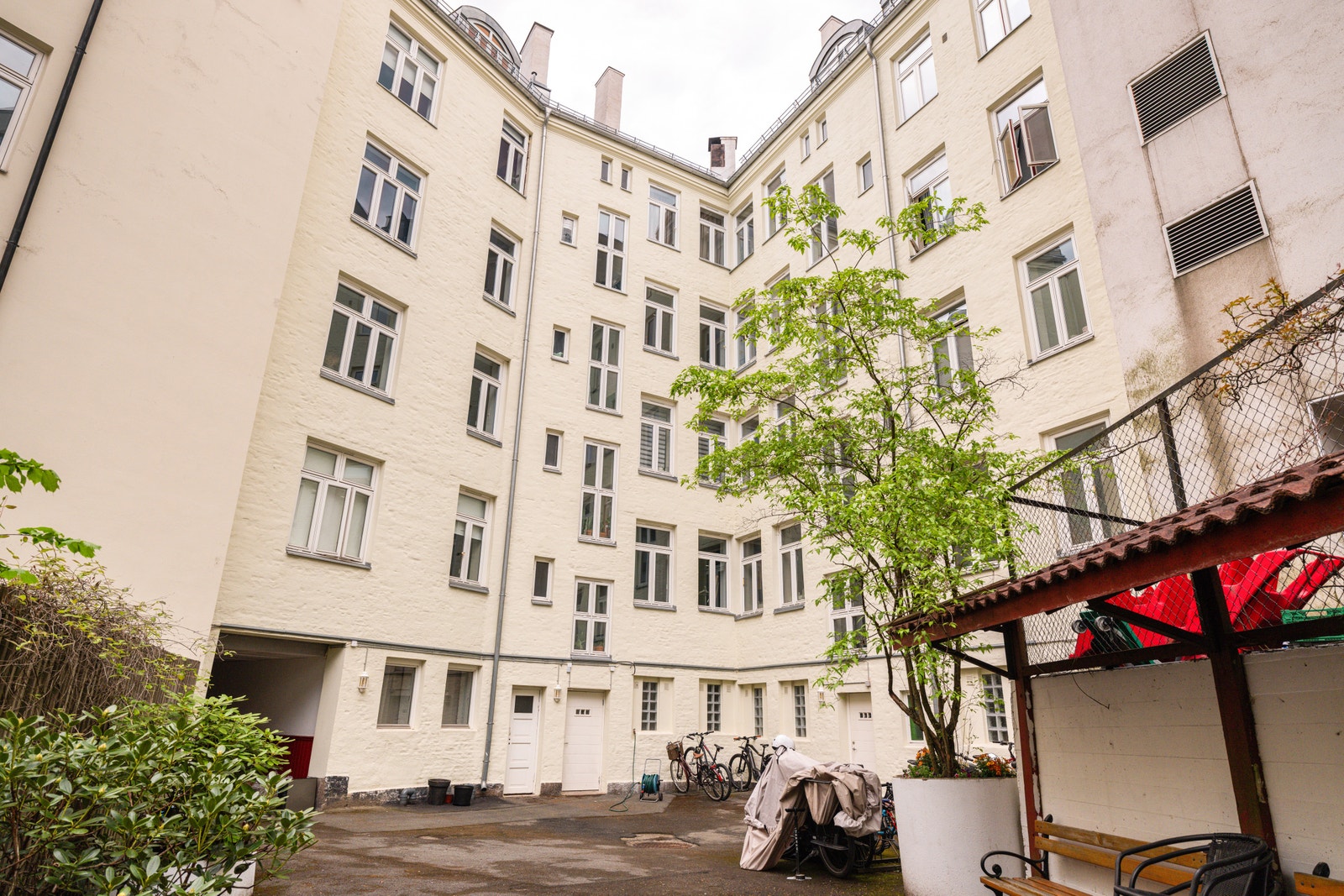 Hyggelig gårdsrom med benker, beplantning og mulighet for sykkelparkering. Galleribilde