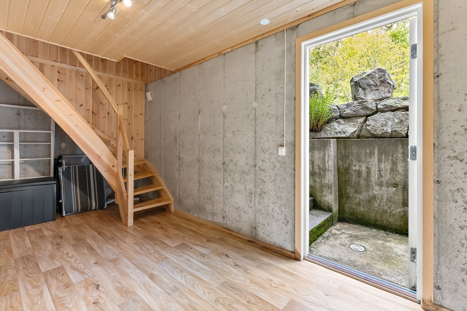 Stort lagerrom med trapp til hovedetasje og utgang til uteområdet. Galleribilde