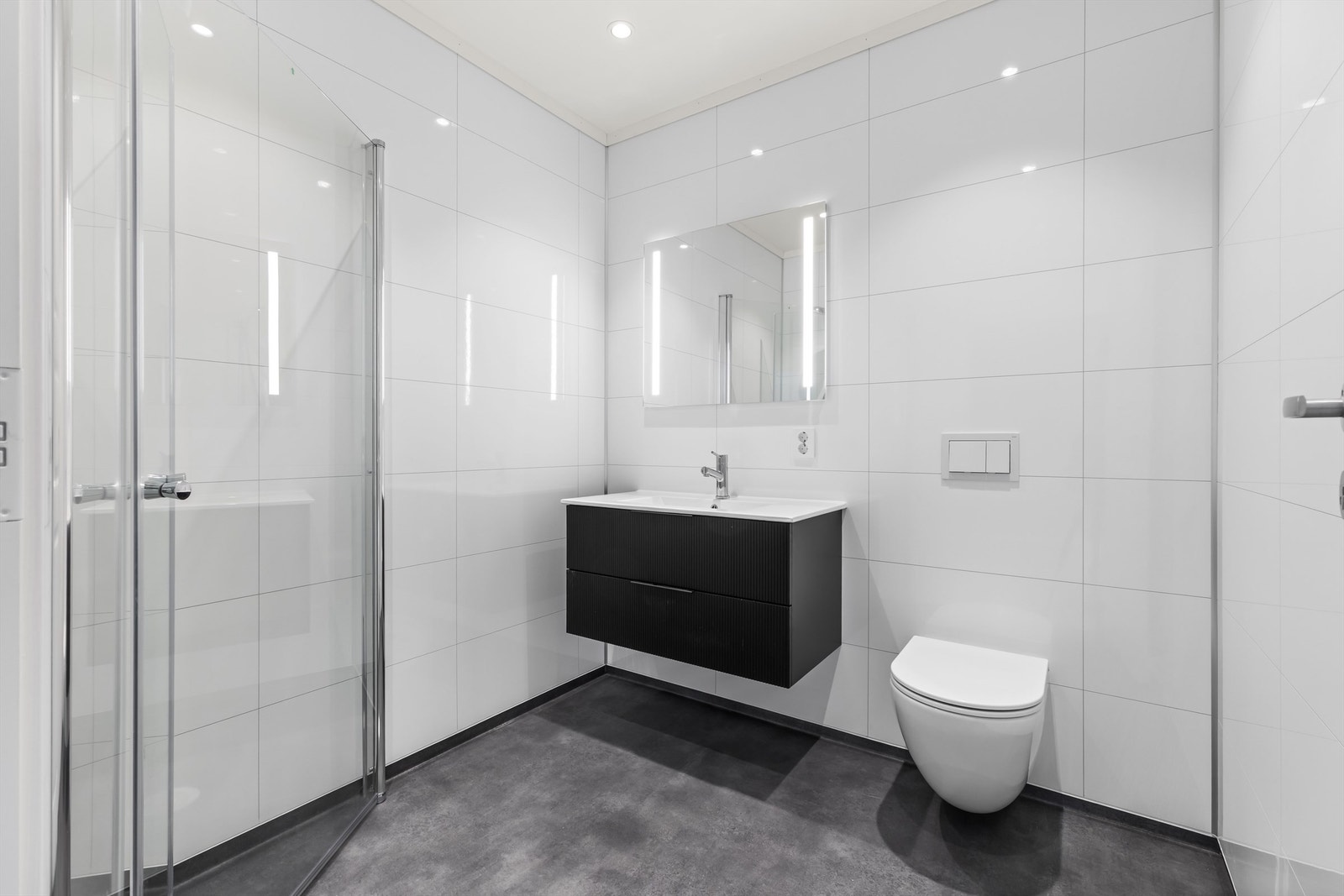 Badet tilknyttet hovedsoverommet har lekker baderomsinnredning og varmekabler i gulvet. Galleribilde