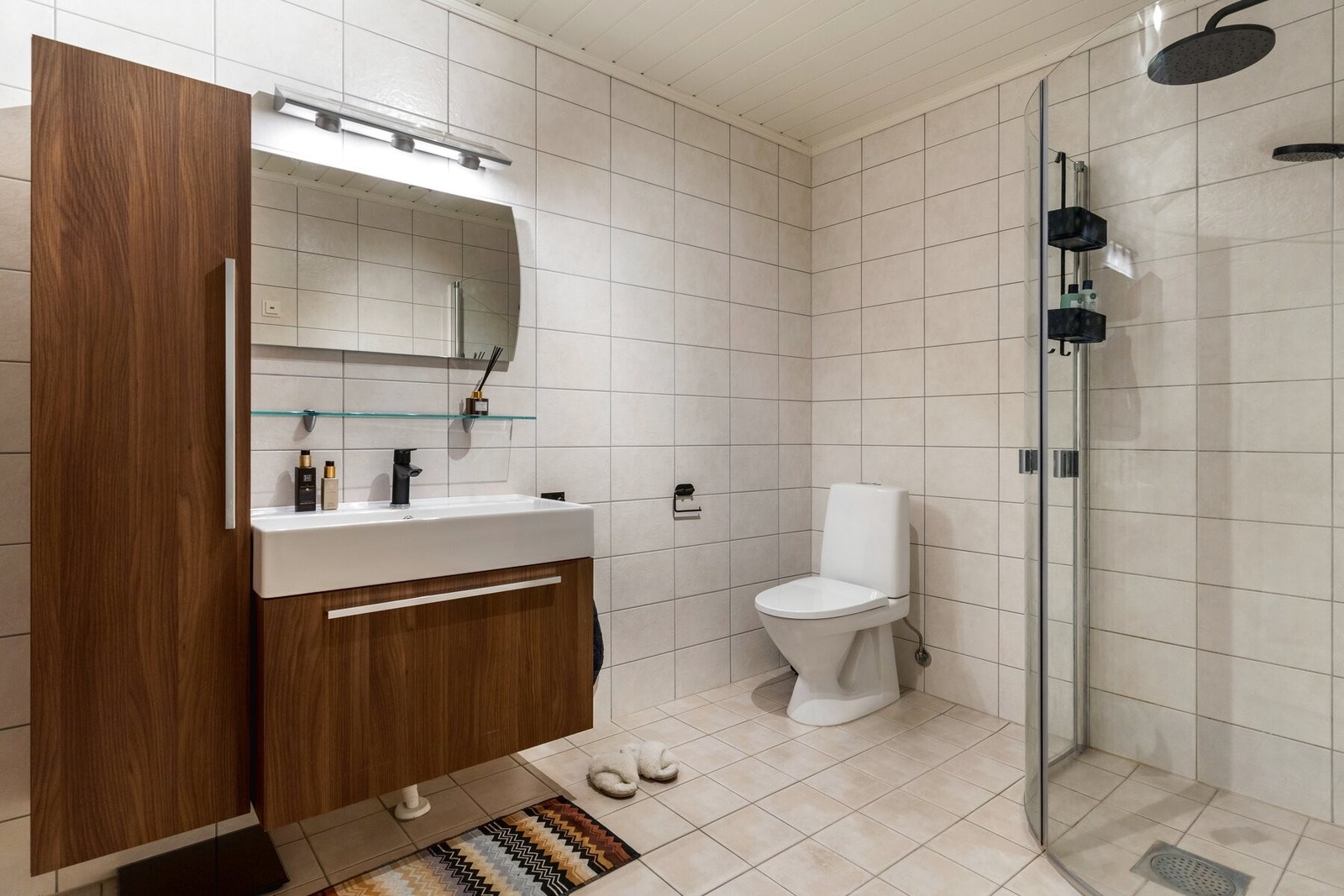 Badet er flislagt og har innredning med Galleribilde