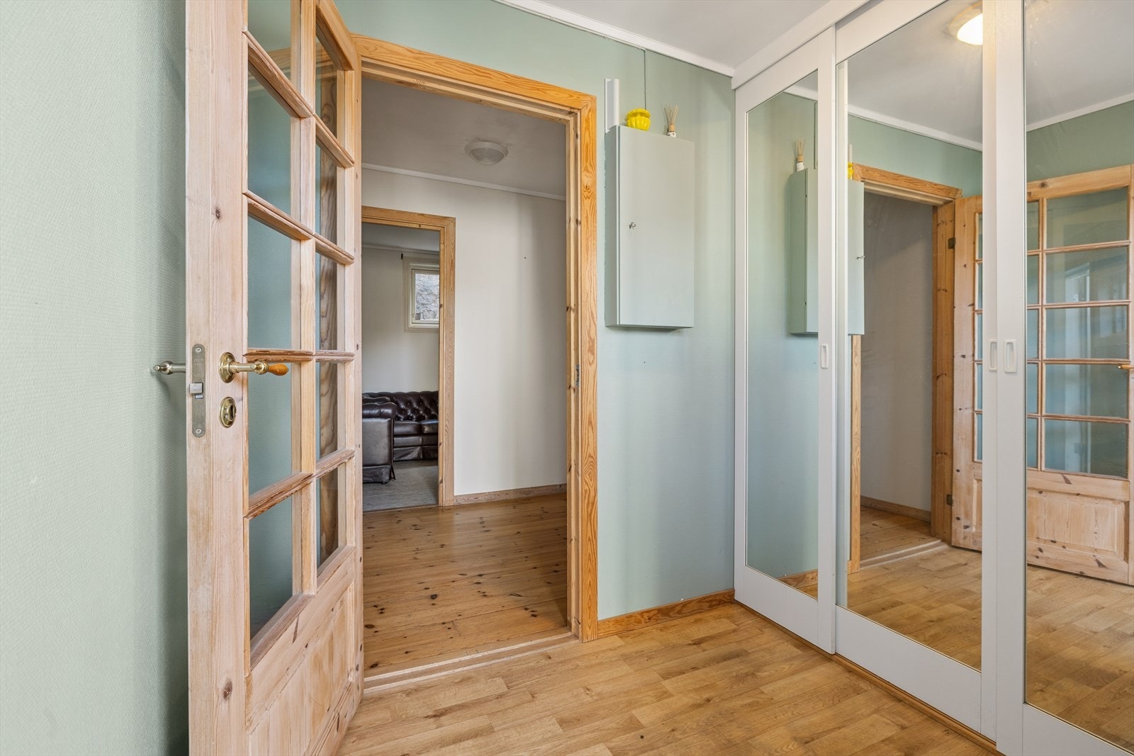Vindfanget i leiligheten ligger på plan 1. Ytterdøren har glassfelt som gir innslipp av naturlig dagslys. Skyvedørsgarderobe med speilfronter. Galleribilde