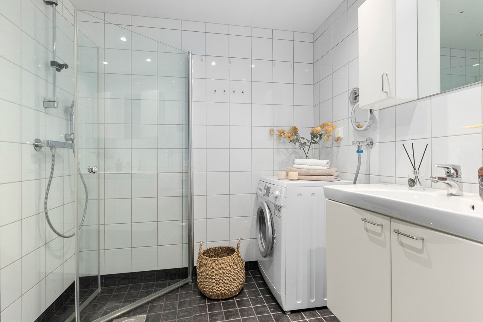 Badet har hvite veggfliser og mørkegrå flis på gulv og holder en god standard. Galleribilde
