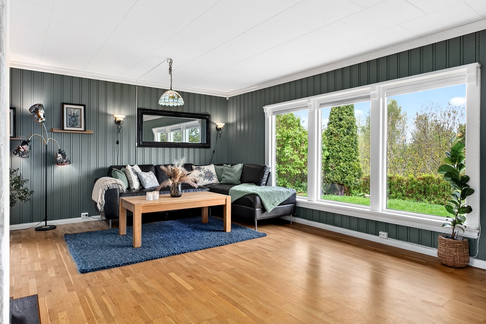 Hyggelig stue med store vinduer som slipper inn rikelig med naturlig lys. Galleribilde