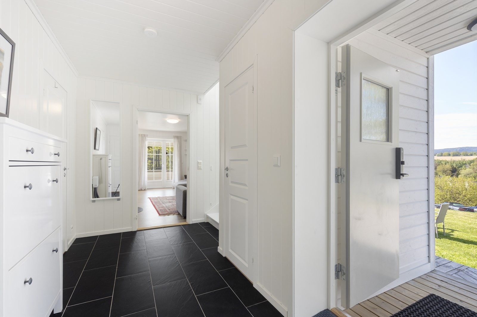 Boligen har en lys og romslig entré/gang med flislagt gulv og god plass til oppbevaringsmøblement for sko- og yttertøy. Galleribilde