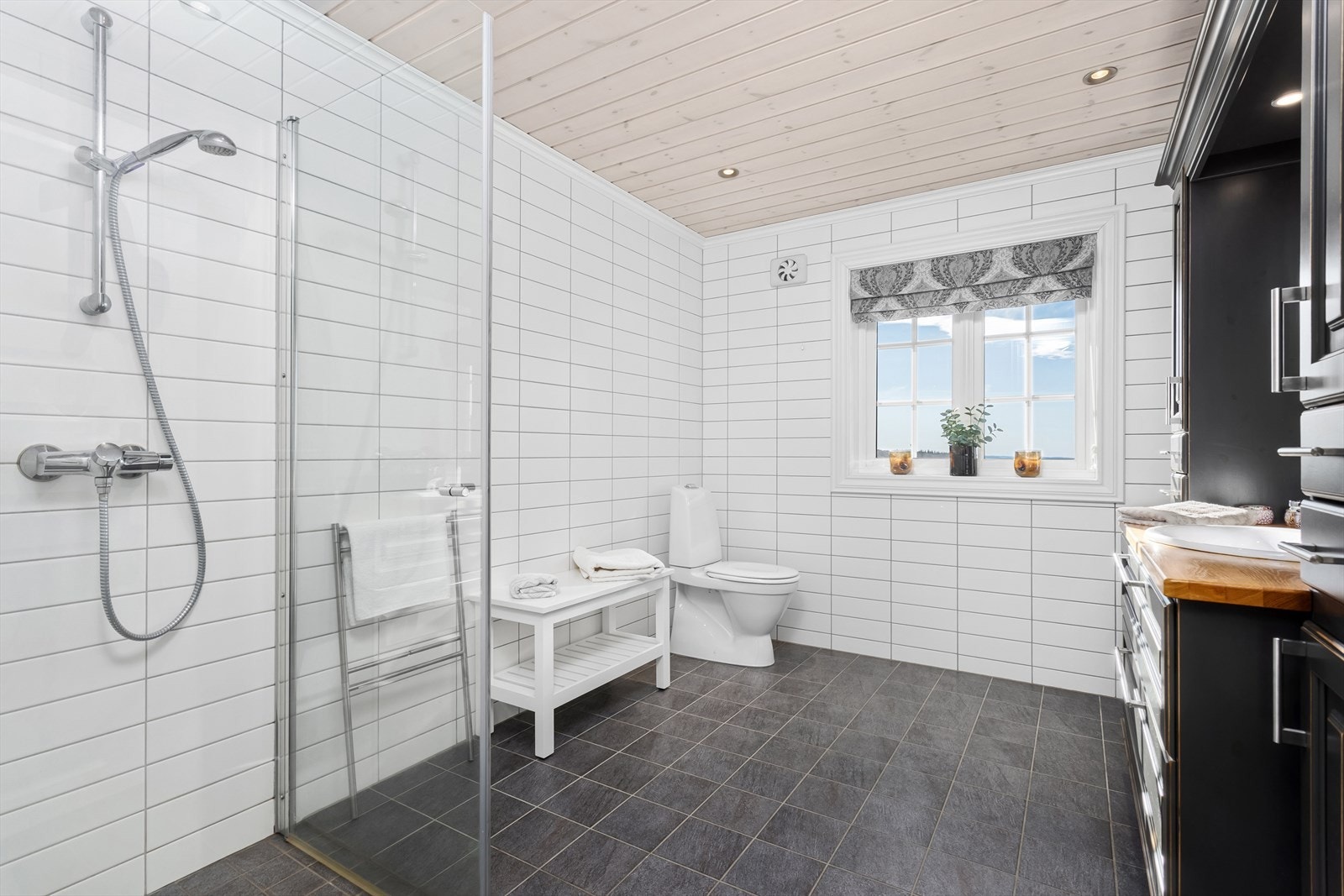 Videre er badet utstyrt med toalett, dusjhjørne med innfellbare dusjvegger. Galleribilde
