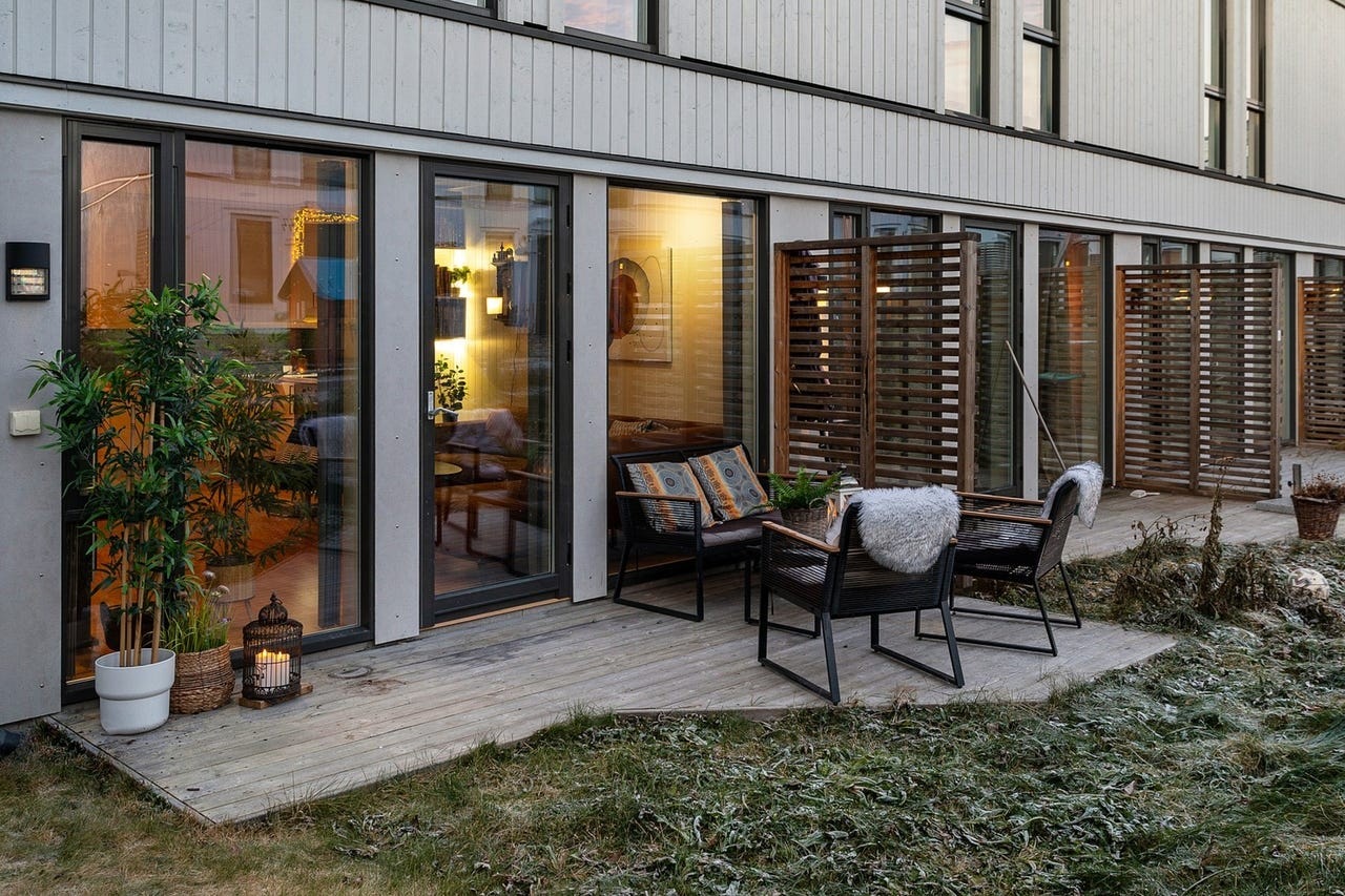 Terrassedekket er bygget i tre og har en skjermvegg mot naboen. Galleribilde