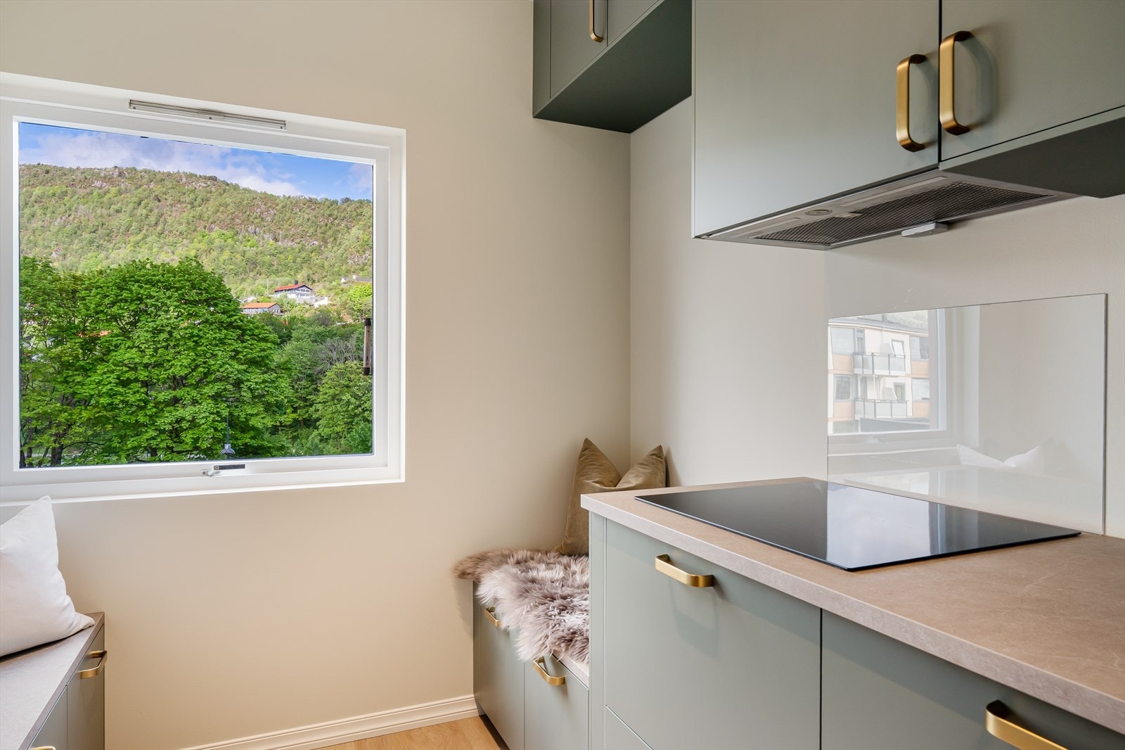Det er i tillegg laget til to benker på kjøkkenet, slik at man enkelt kan sette inn et bord - herfra kan man nyte utsikten mot Landåsfjellet Galleribilde