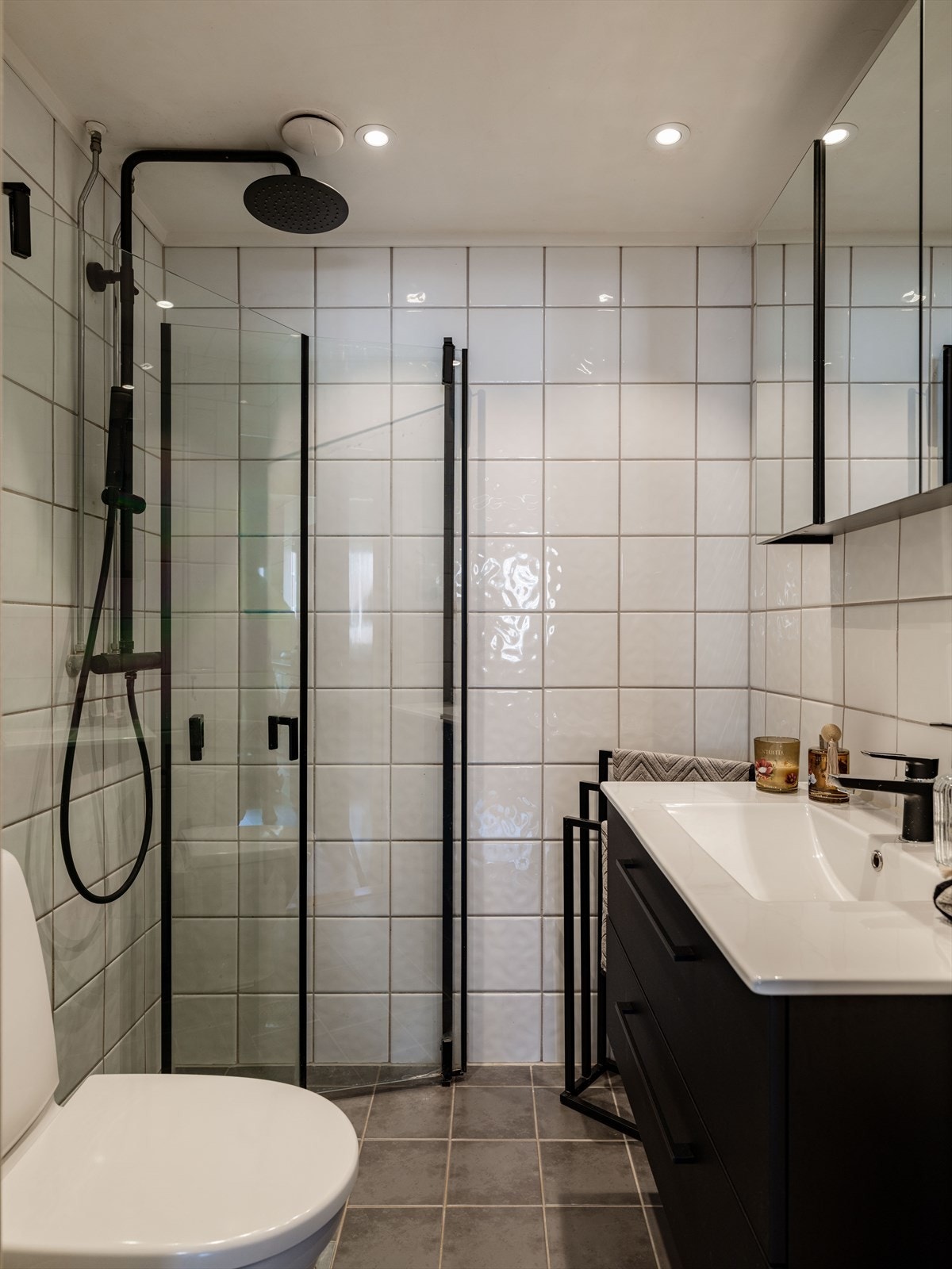 Badet er innredet med klosett, dusjhjørne, servant med underskuffer og speilskap med oppbevaring. Galleribilde