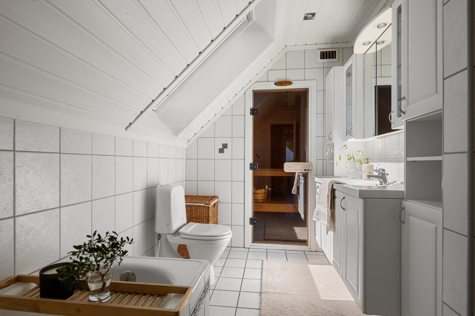 Leilighetens andre bad ligger i øverste etasje i tilknytning til soverommene. Badet har flislagte gulv og vegger, malt panel i himling med downlights, samt gulvvarme. Deler av rommet ved kneveggen er byggemeldt som kott. Galleribilde