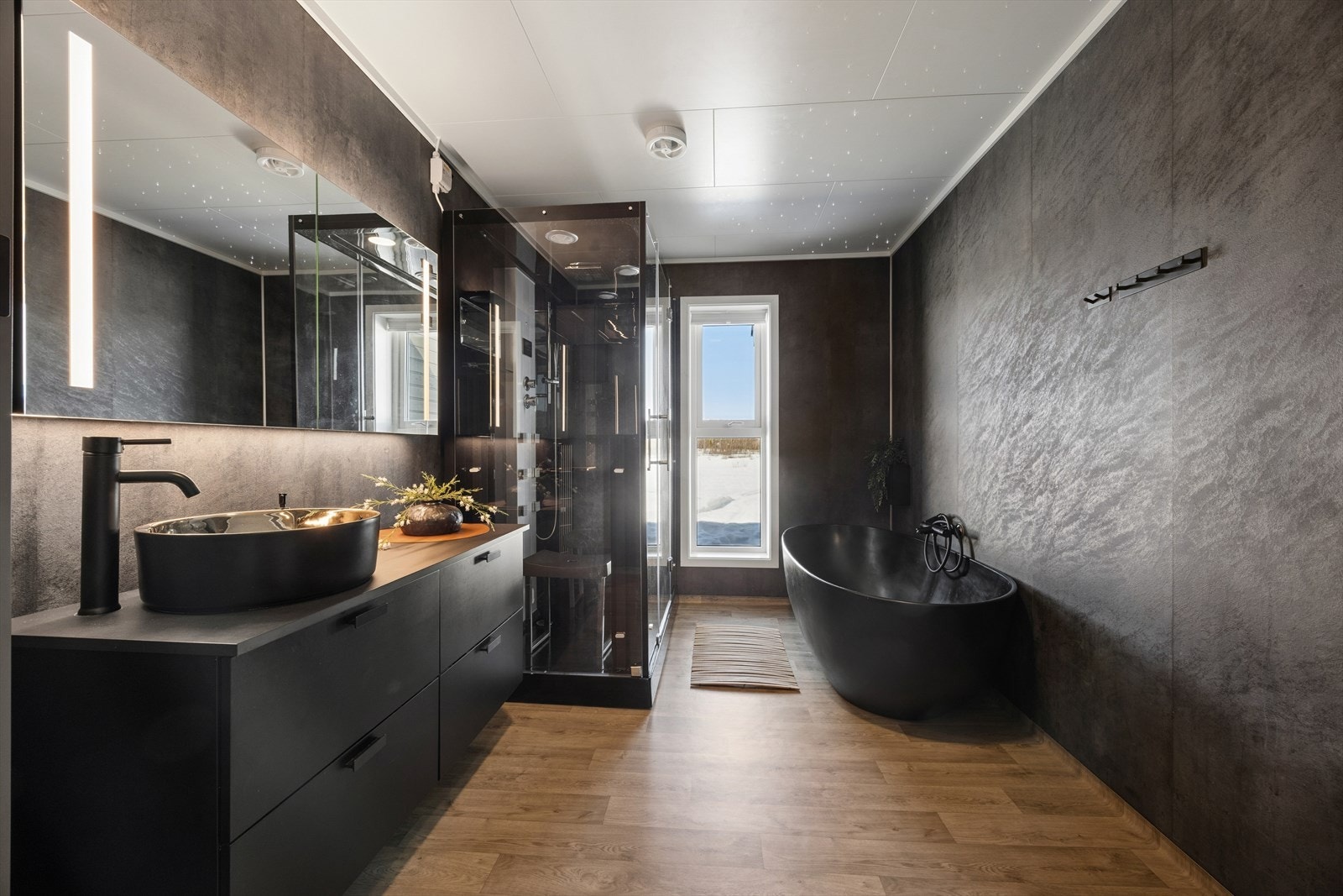 Badet har baderomsplater på veggene og vinylbelegg på gulvet med elektriske varmekabler. Galleribilde