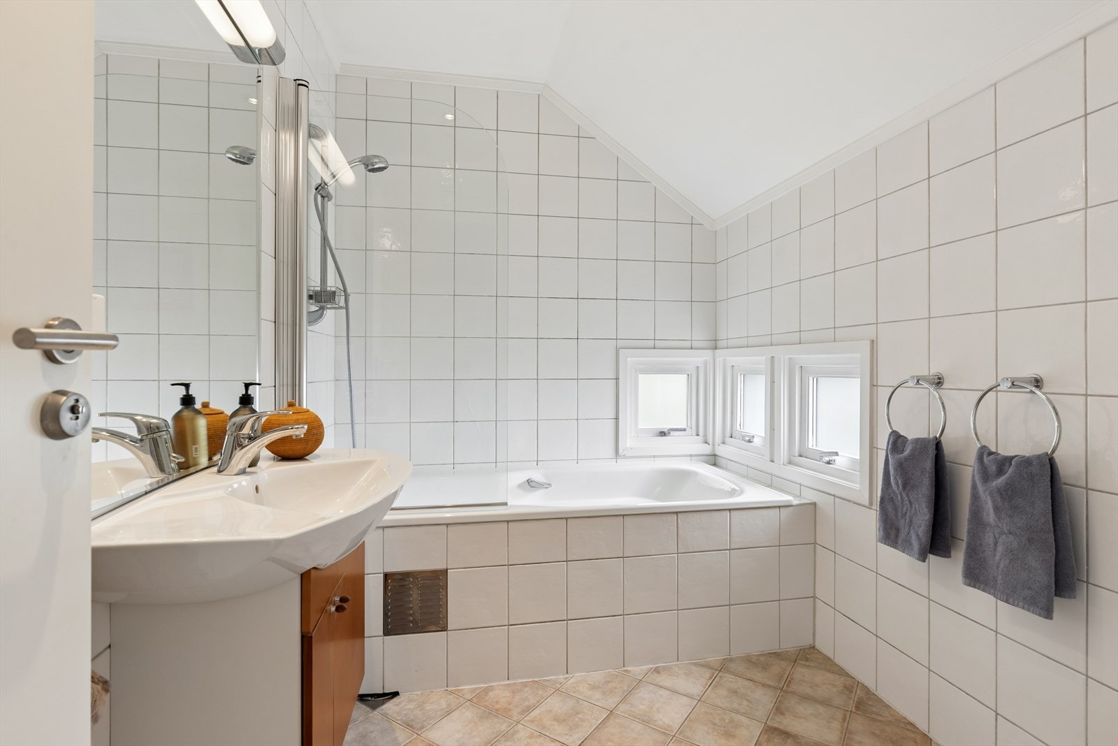 Badet har flislagte vegger, flislagt gulv og et malt tak med innfelte downlights. Rommet er også utstyrt med en avslappende badekar. Galleribilde