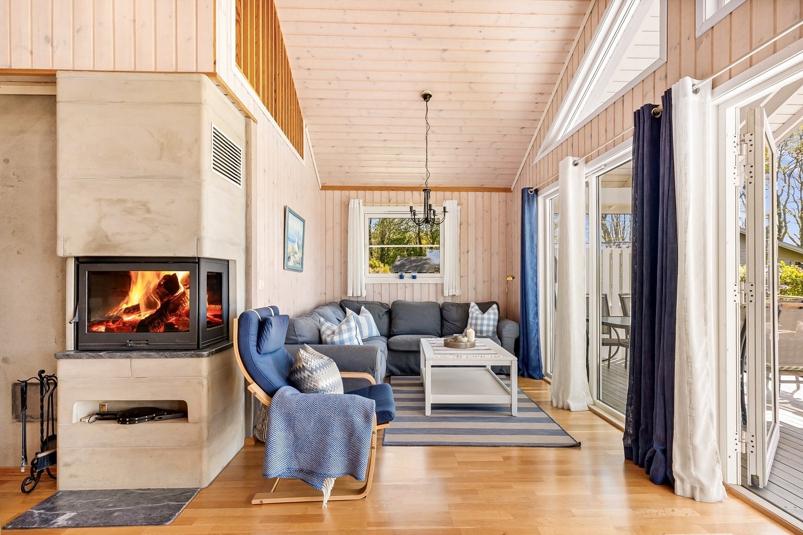 Stuen i østfløyen har åpen himling som gir en god romfølelse, og en Dovre peisinnsats for varme og hygge. Galleribilde