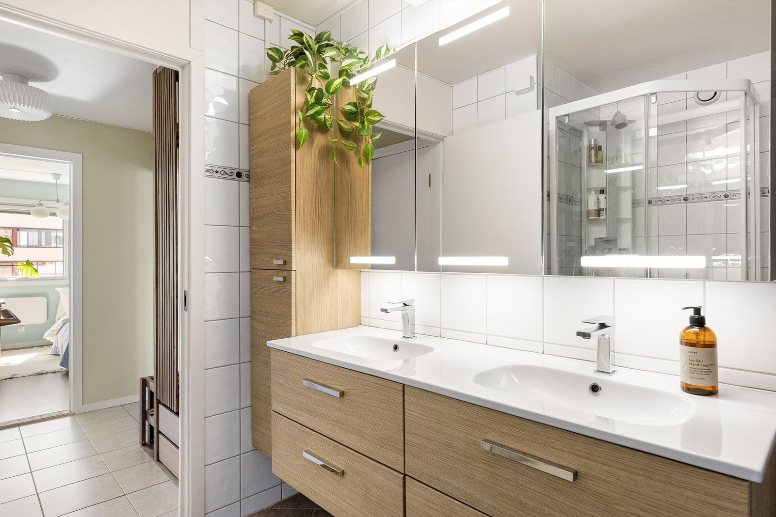 Badet har innredninger fra 2025 med dobbel nedfelt servant, overhengende speil og belysning. Videre er det montert opplegg for vaskemaskin og elektriske varmekabler er installert i gulvet. Galleribilde