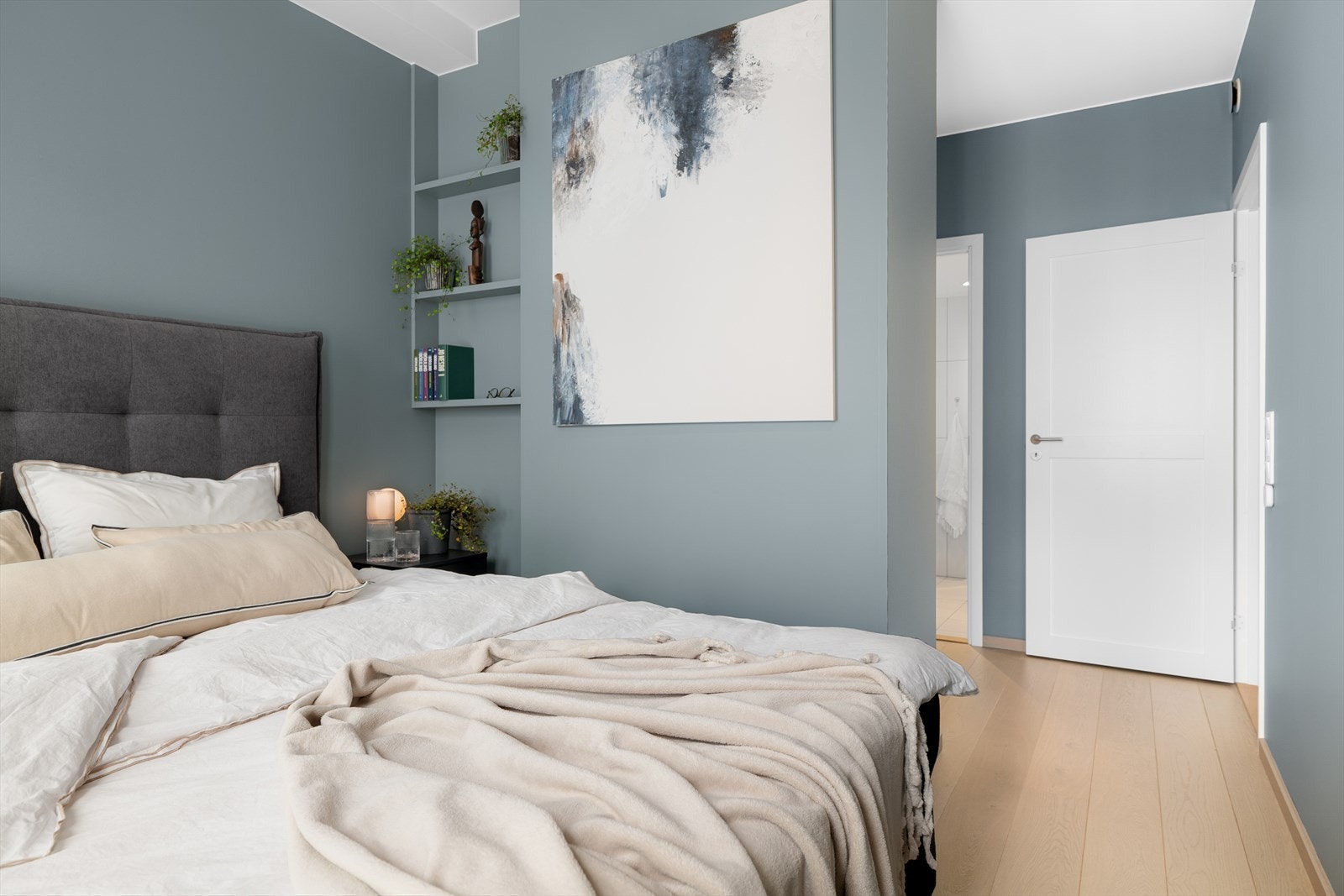 Det er plass til nattbord på hver side av sengen, og i veggen har man laget smarte integrerte hyller for ekstra oppbevaringsplass. Galleribilde