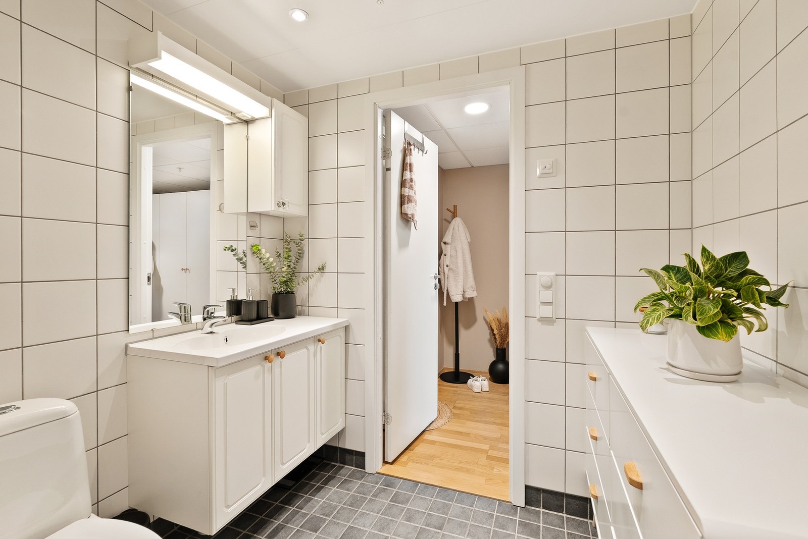 Romslig bad med innredning, toalett og dusjhjørne. Galleribilde