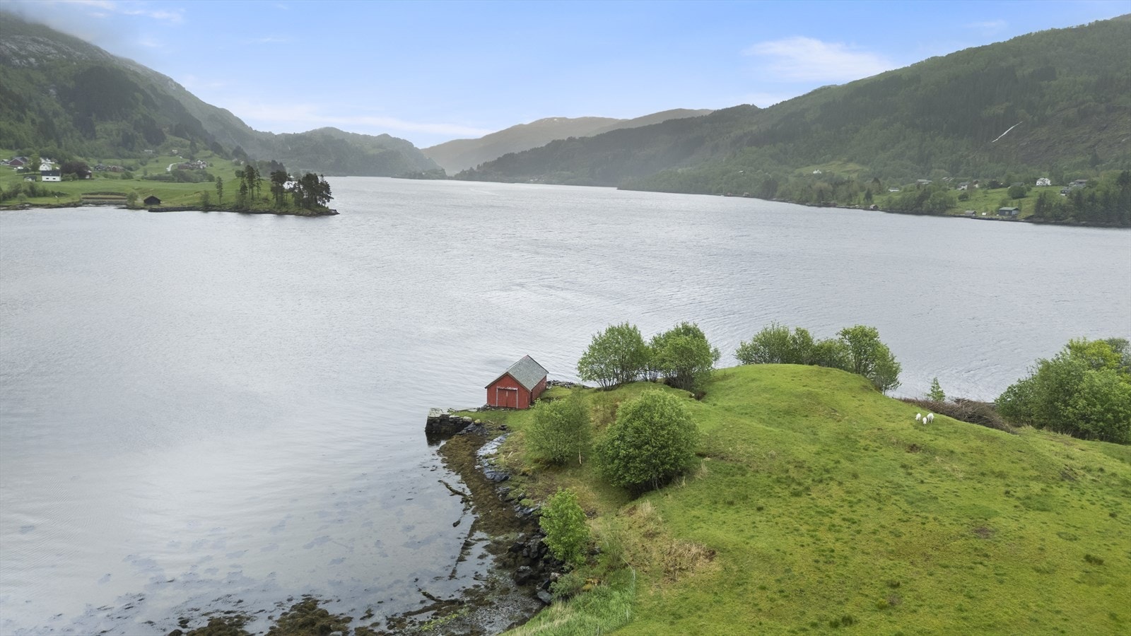 Nede ved fjorden er det naust og steinmolo Galleribilde