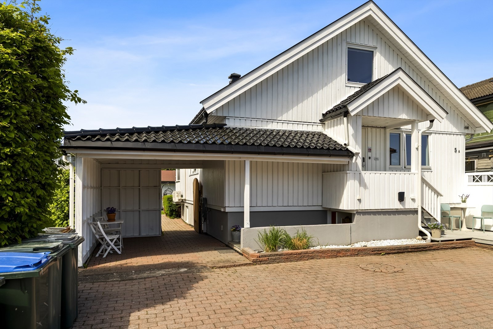Det medfølger en tilhørende og praktisk carport på ca. 14 kvm. På husveggen i carporten er det montert en moderne el-billader for trygg og enkel lading av kjøretøy. Galleribilde
