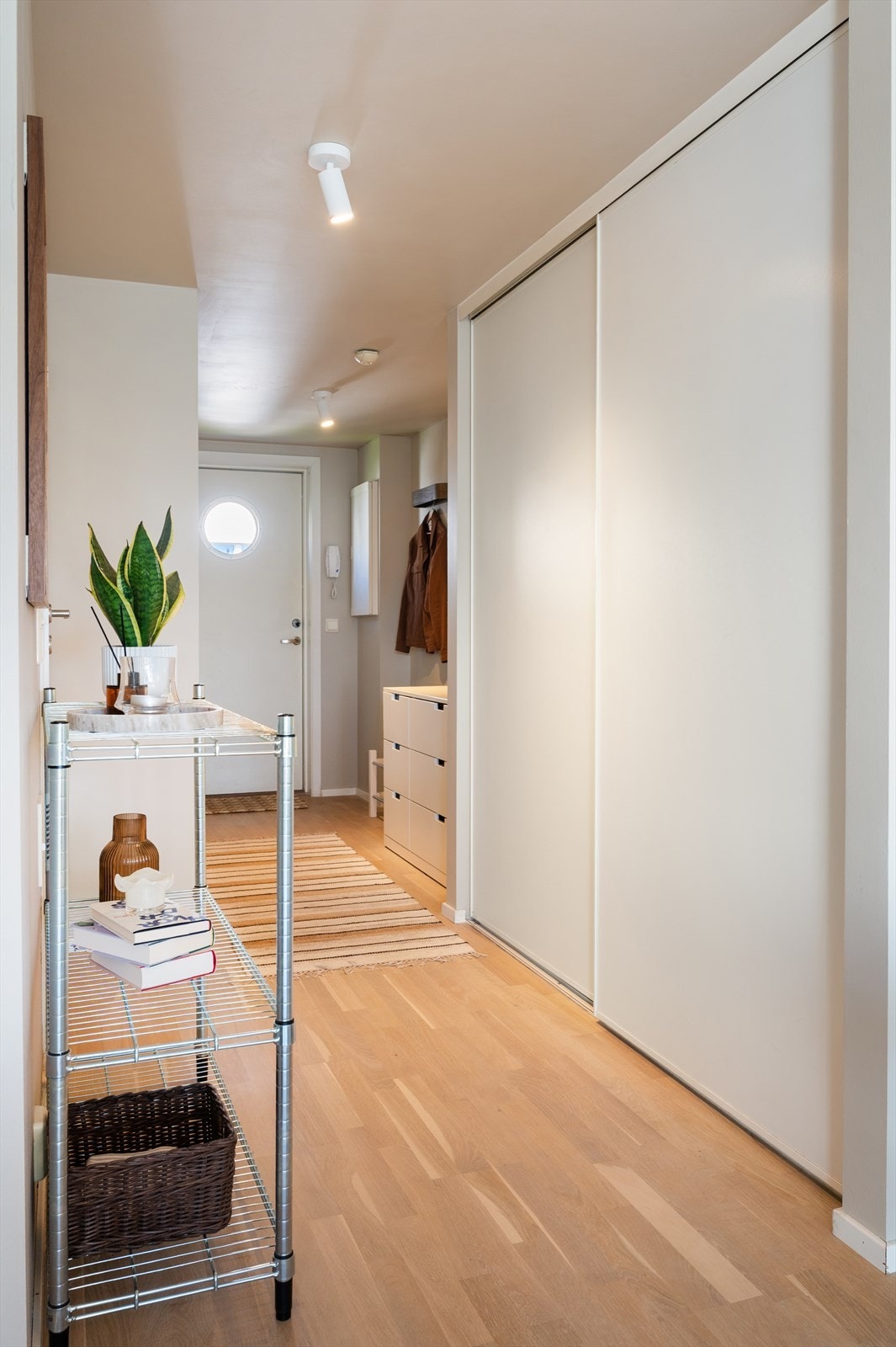 Mellomgang med stor, praktisk skyvedørsgarderobe som gir rikelig med oppbevaring. Galleribilde