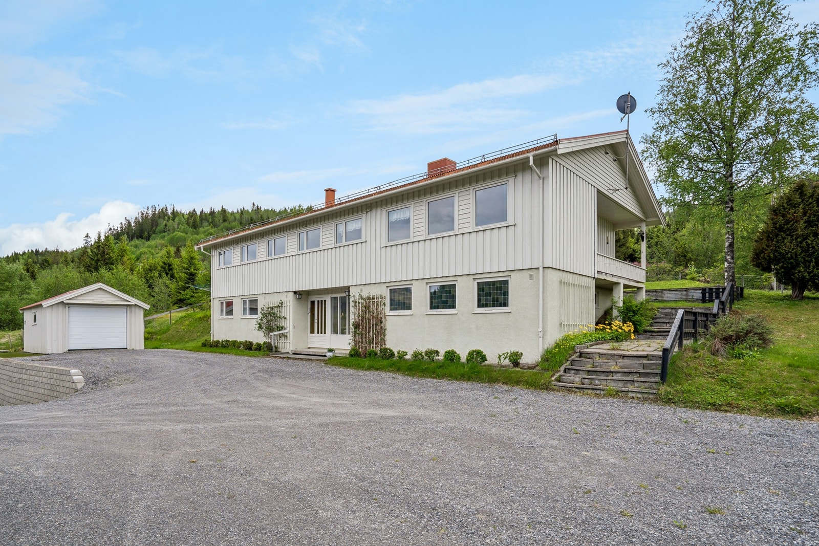 Rikelig med parkeringsplass på den gruslagte gårdsplassen, samt. 2 garasjer. Galleribilde