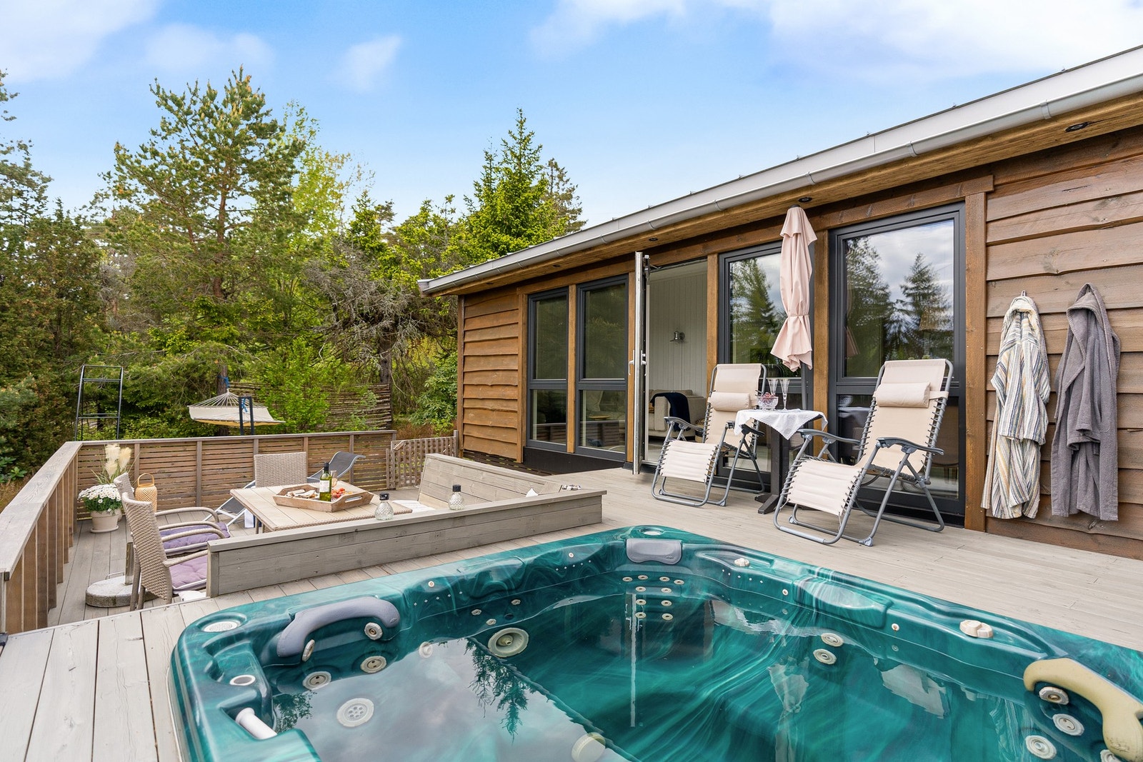 Stor, solrik veranda med jacuzzi - et perfekt sted å nyte rolige kvelder med utsikt mot fjorden. Galleribilde