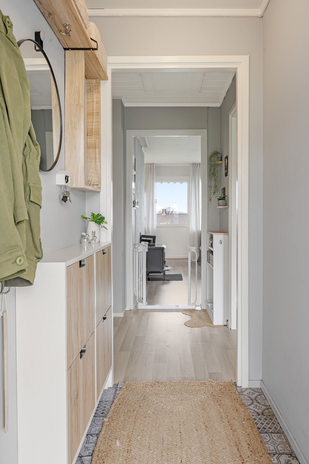 Entréen har god standard med nydelige vinylfliser fra ca. 2024 på gulv og glatte malte overflater. Galleribilde