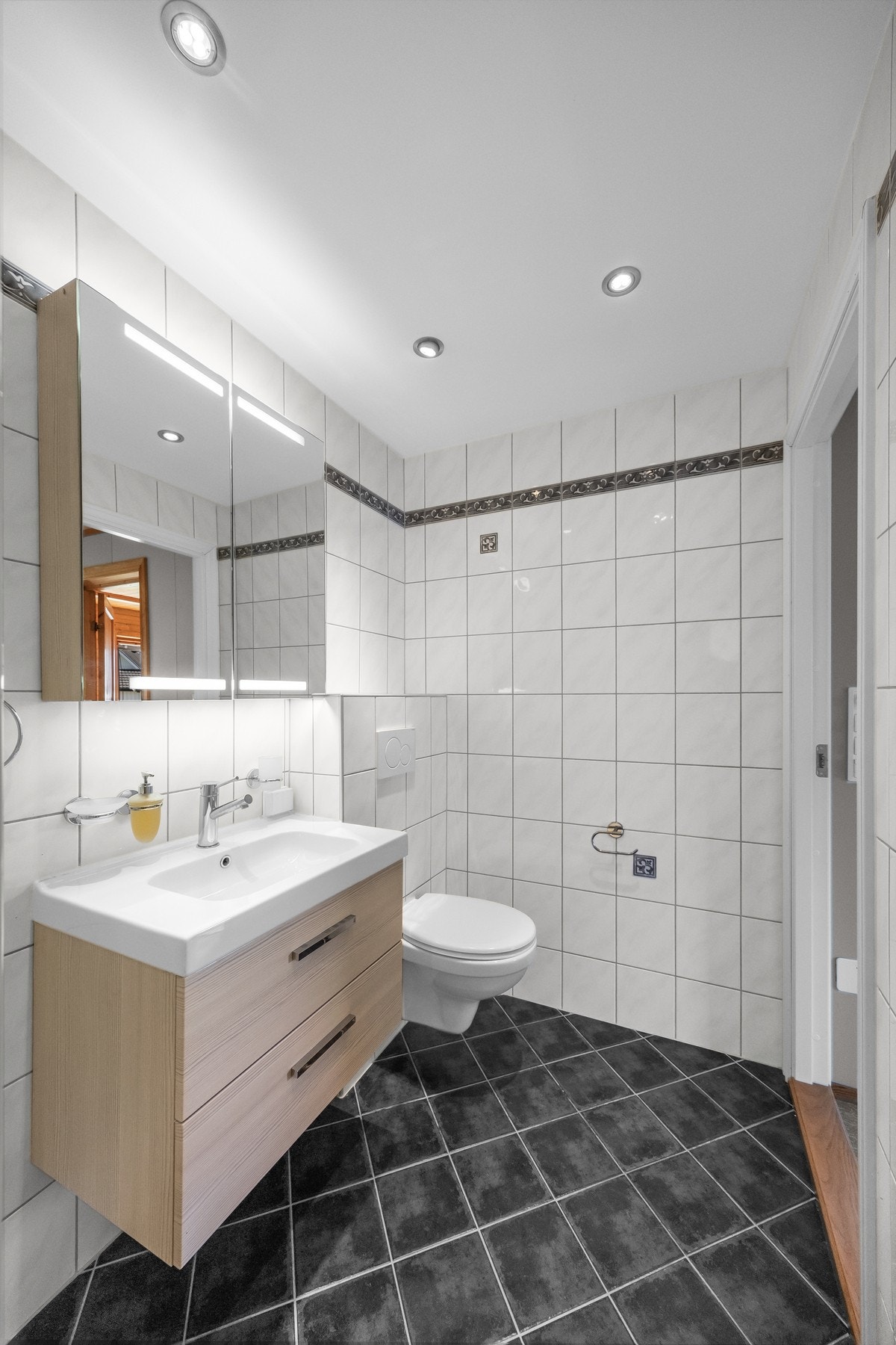 Det er montert downlights. Badet er innredet med servantskap med glatte fronter og heldekkende servant Galleribilde