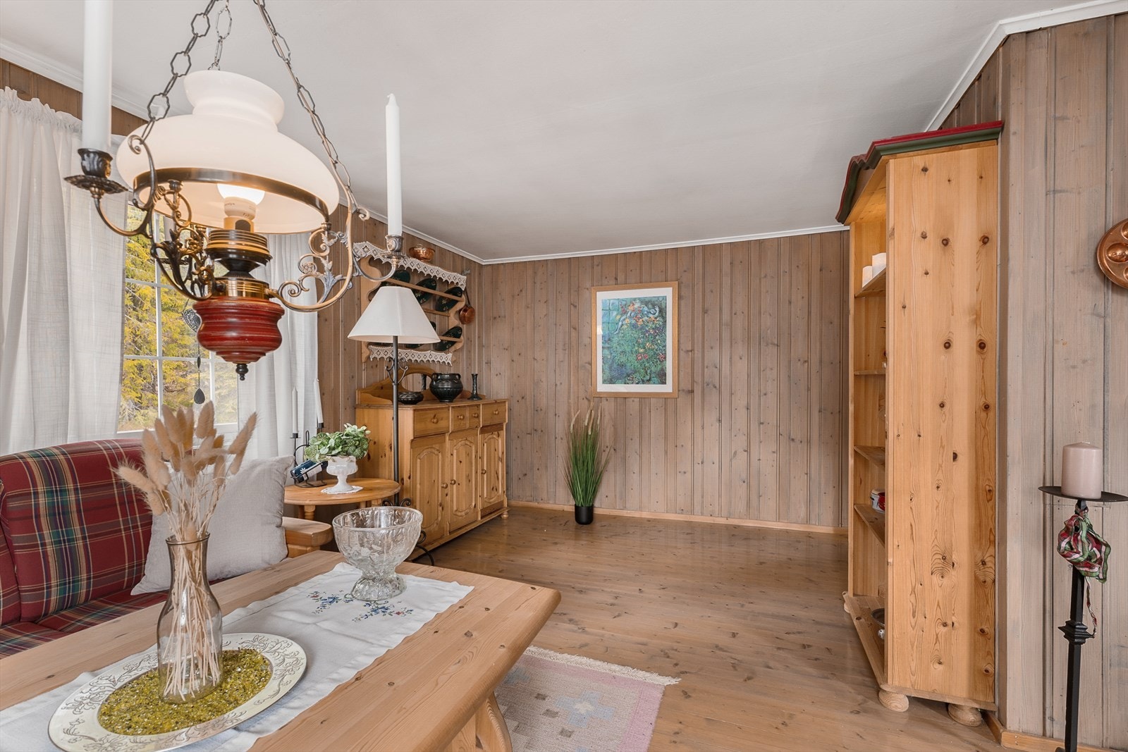 De gjennomgående overflatene med furugulv og trepanel gir en klassisk og lun hyttestemning. Galleribilde