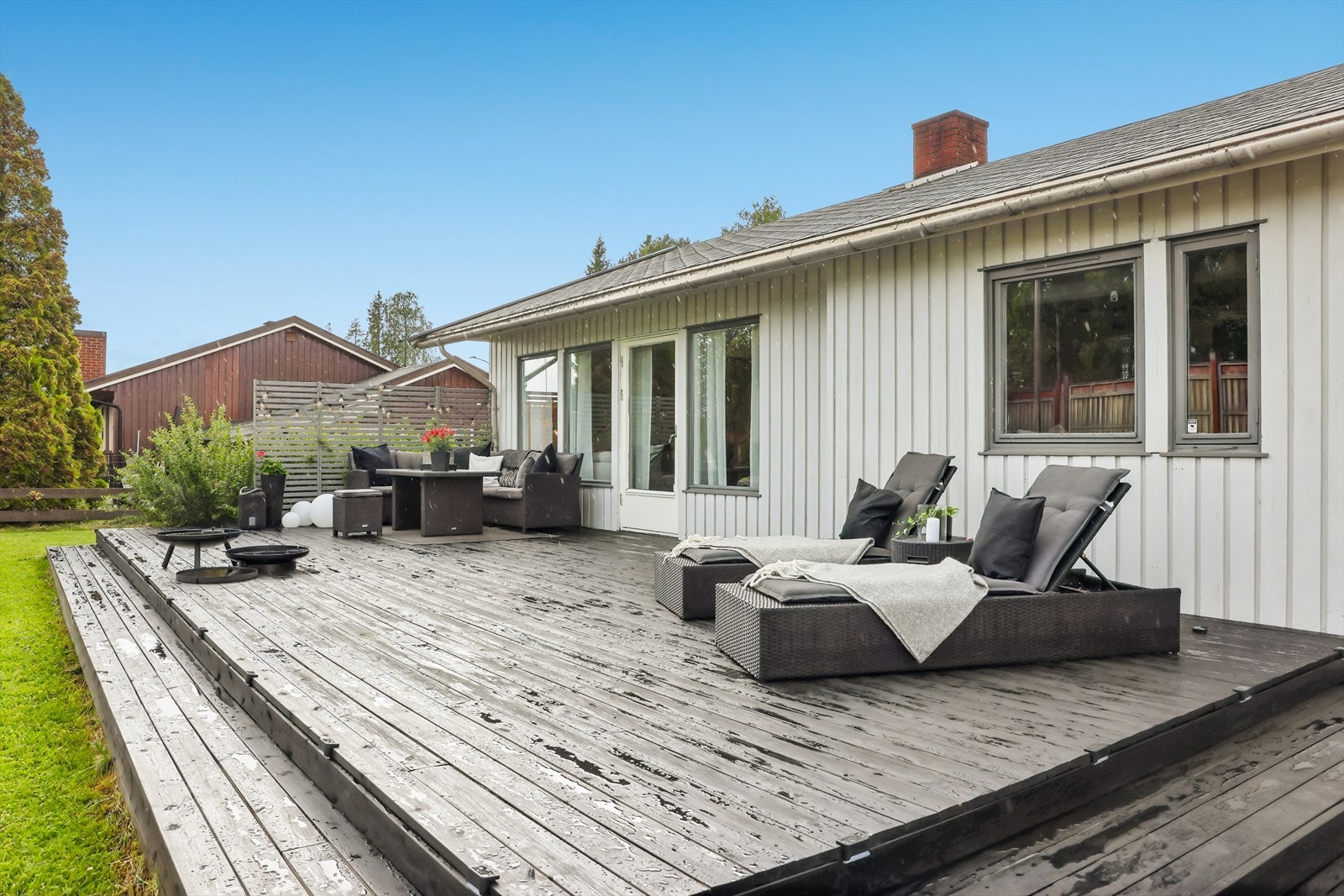 Stor terrasse mot hagen, med plass til flere sittegrupper og enkel adkomst fra stuen. Galleribilde