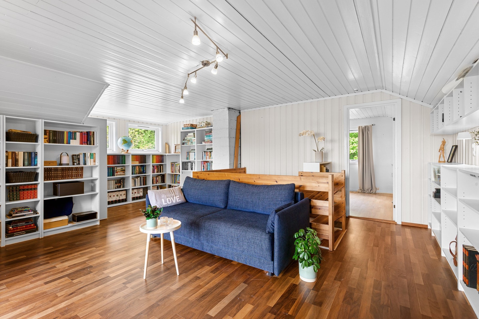 Et lyst og allsidig rom med plassbygde bokhyller, perfekt som en ekstra stue eller bibliotek. Rommet er ikke bruksendret/omsøkt. Galleribilde