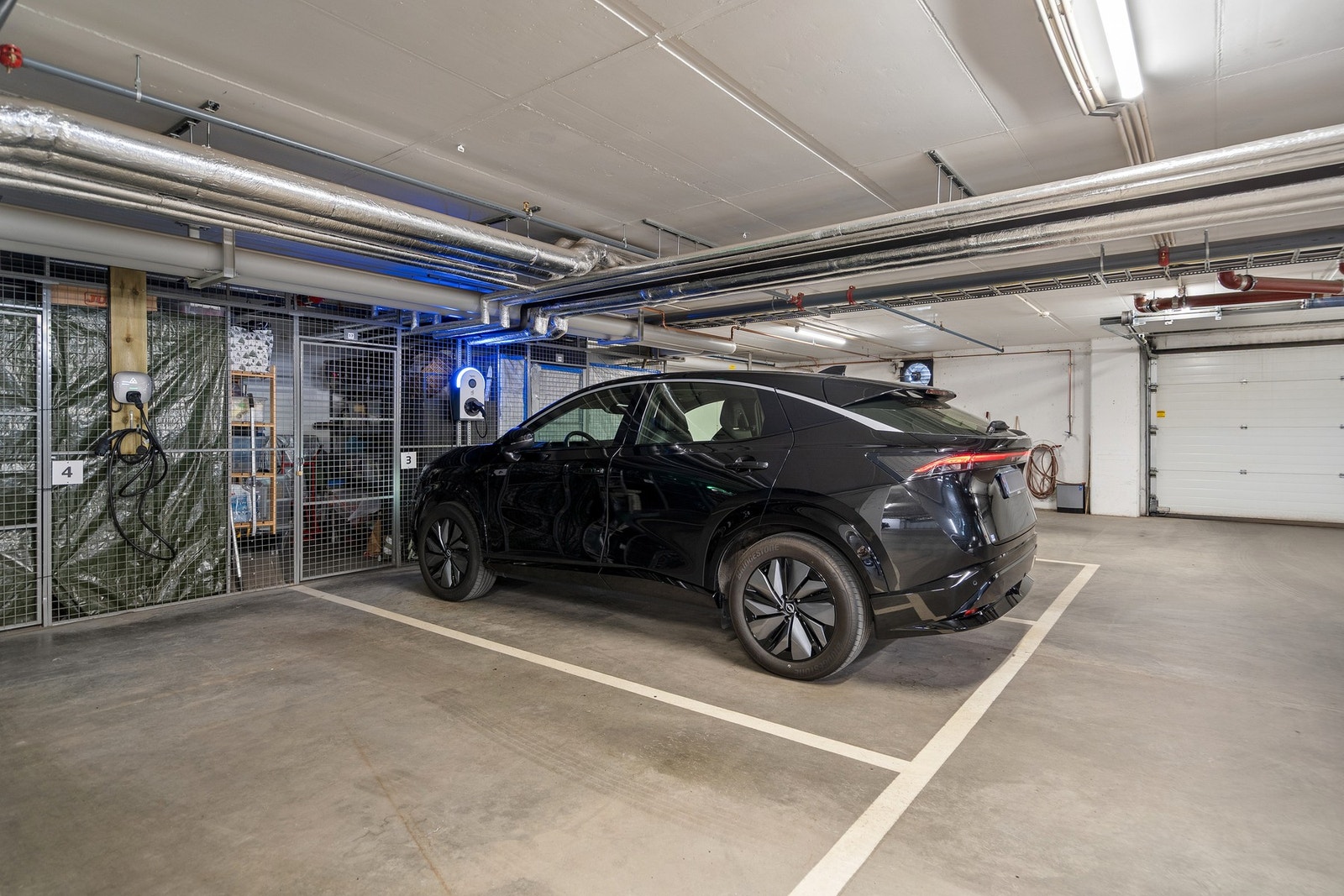 Garasjeplass med bod bak Galleribilde