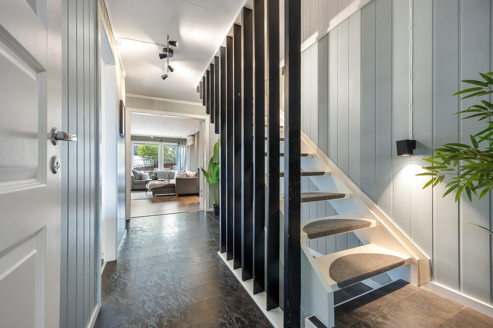 Trappen binder etasjene sammen og har en stilren design med spiler som slipper lyset gjennom. Galleribilde