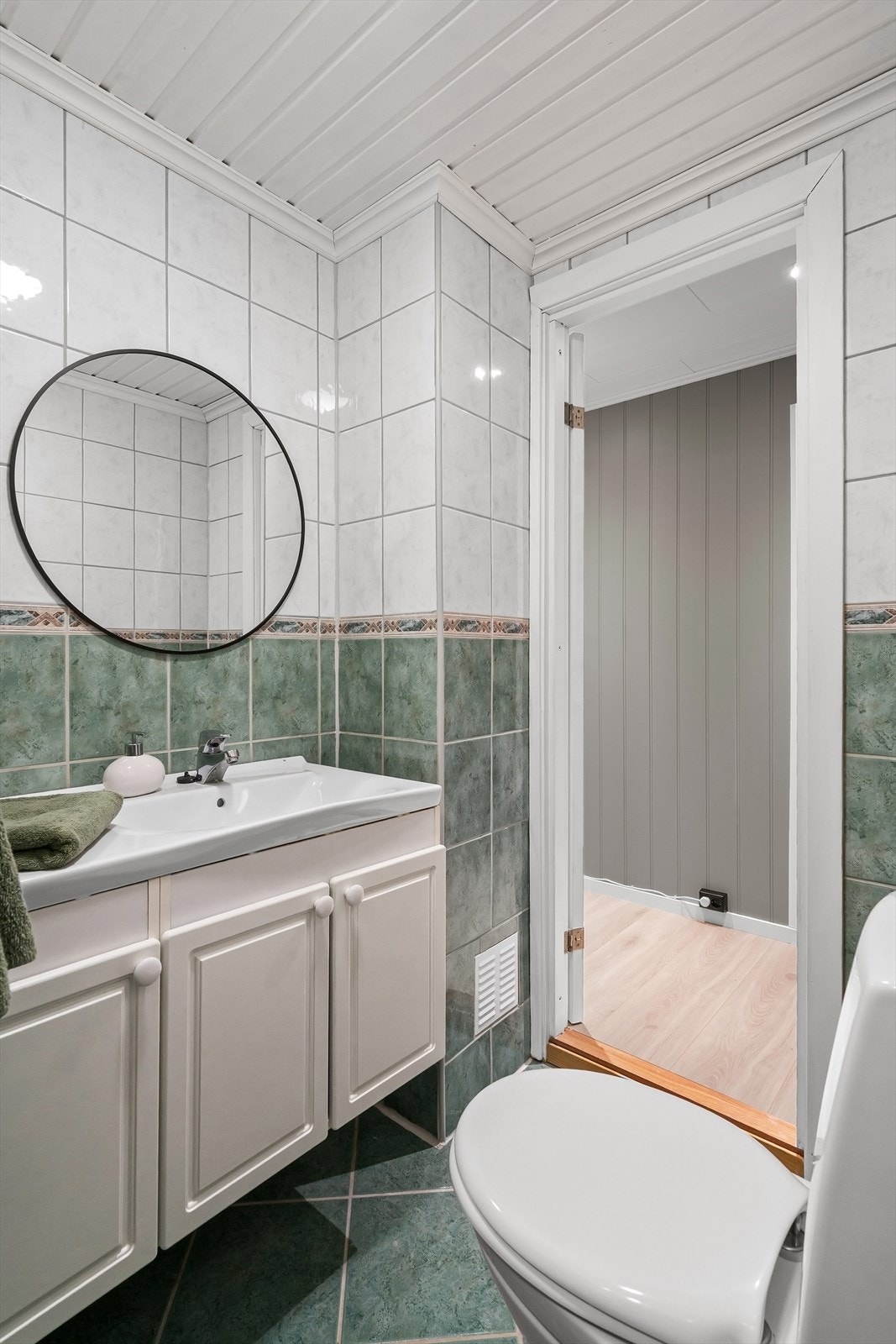 Badet er utstyrt med servant, toalett og dusjhjørne. Galleribilde