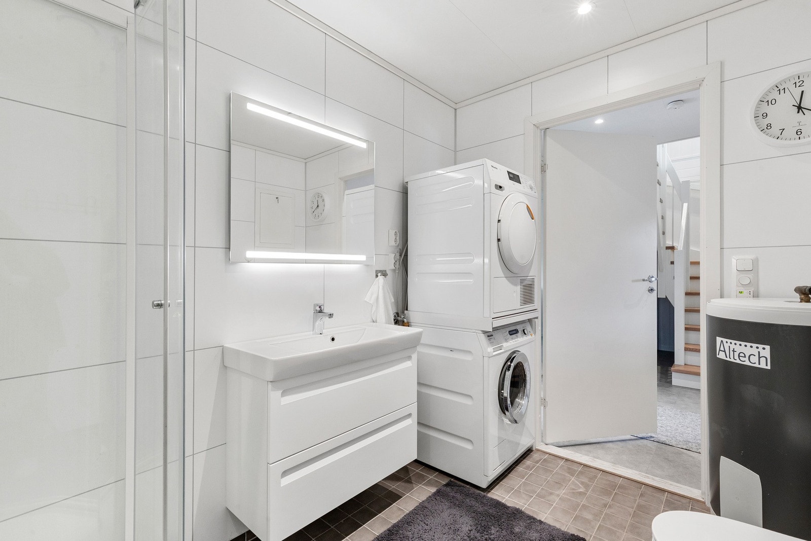Badet er utstyrt med bereder, rørfordelingsskap, veggmontert wc, dusjkabinett, servantskap og opplegg for vaskemaskin. Galleribilde