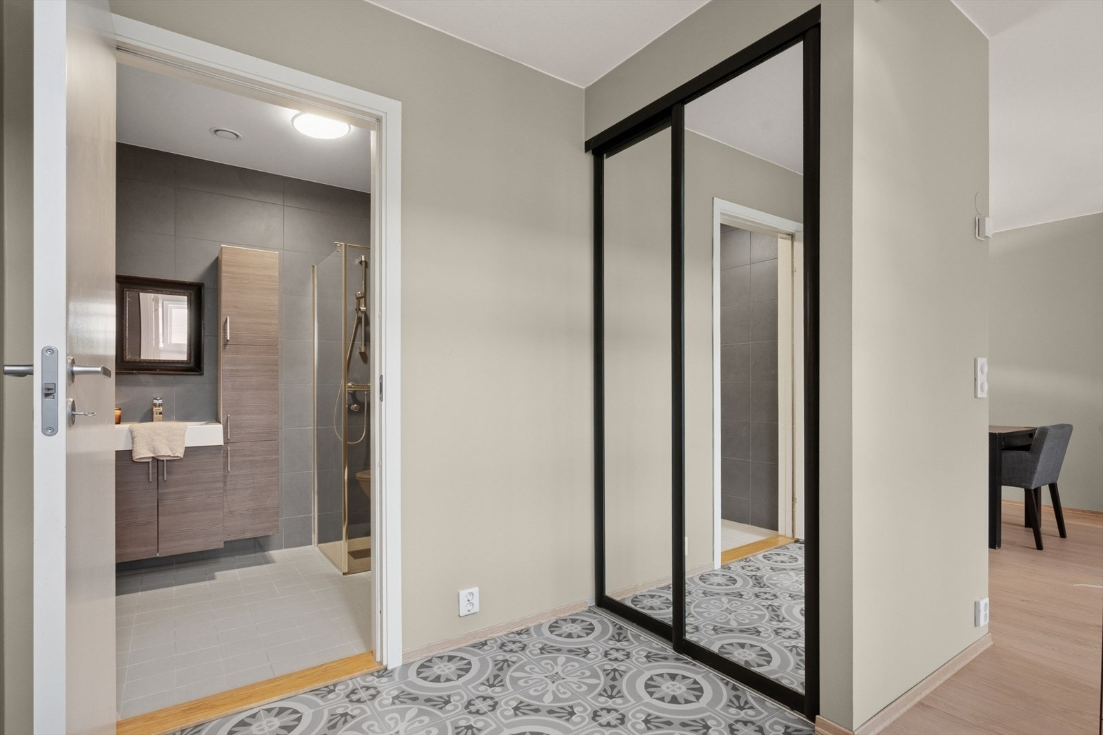 Entréen er innredet med skyvedørsgarderobe og har direkte tilgang til ett av boligens 2 bad Galleribilde