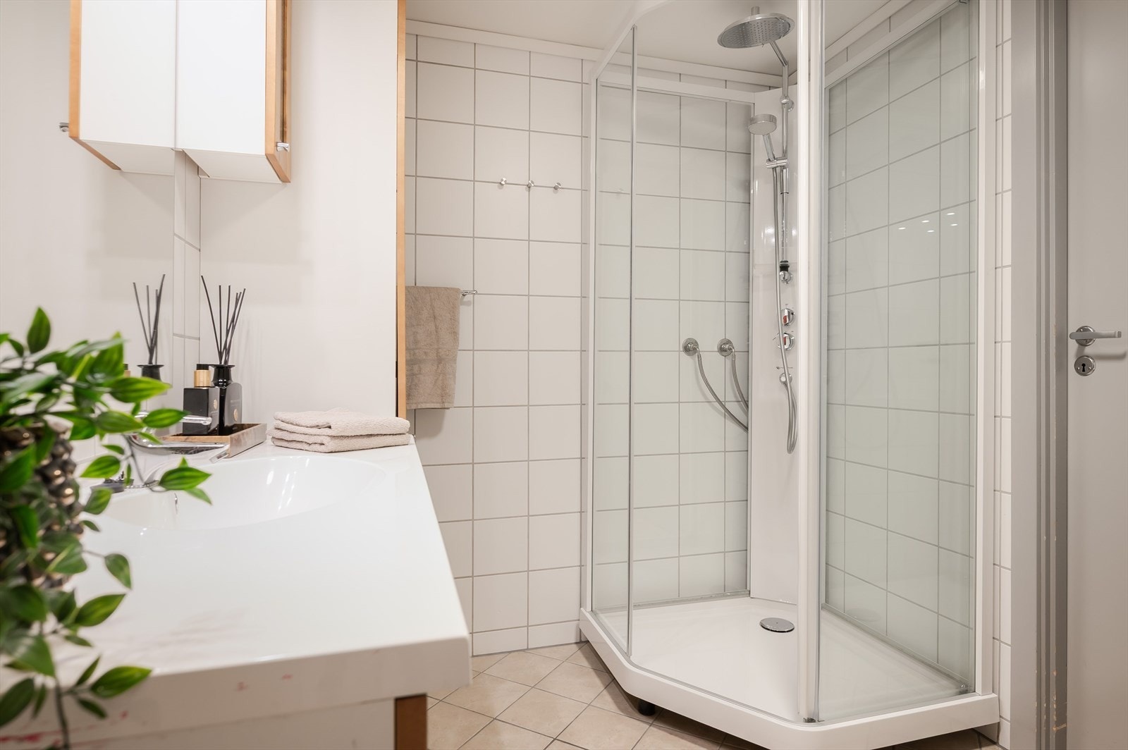 Badet har dusjkabinett, gulvmontert toalett og en romslig baderomsinnredning med heldekkende servant. Godt med oppbevaringsplass på badet. Det er også opplegg for vaskemaskin. Galleribilde