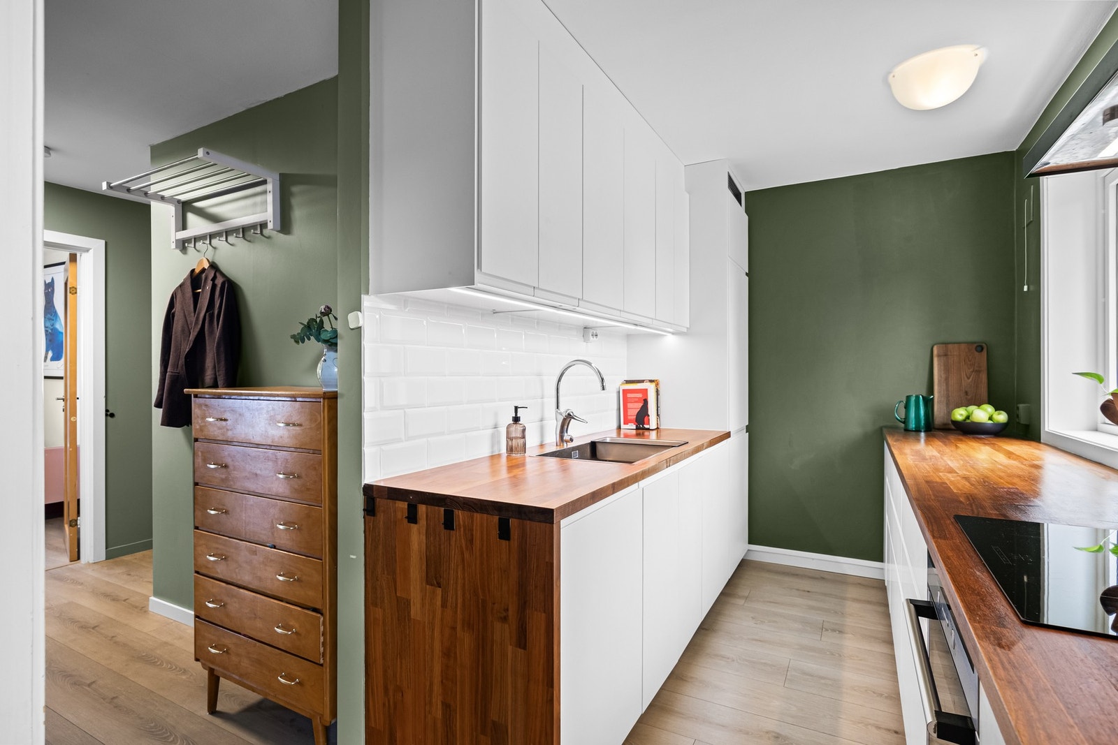 Det er utstyrt med blant annet heltre benkeplate, svart ventilatorhette og dobbel kum i rustfritt stål Galleribilde